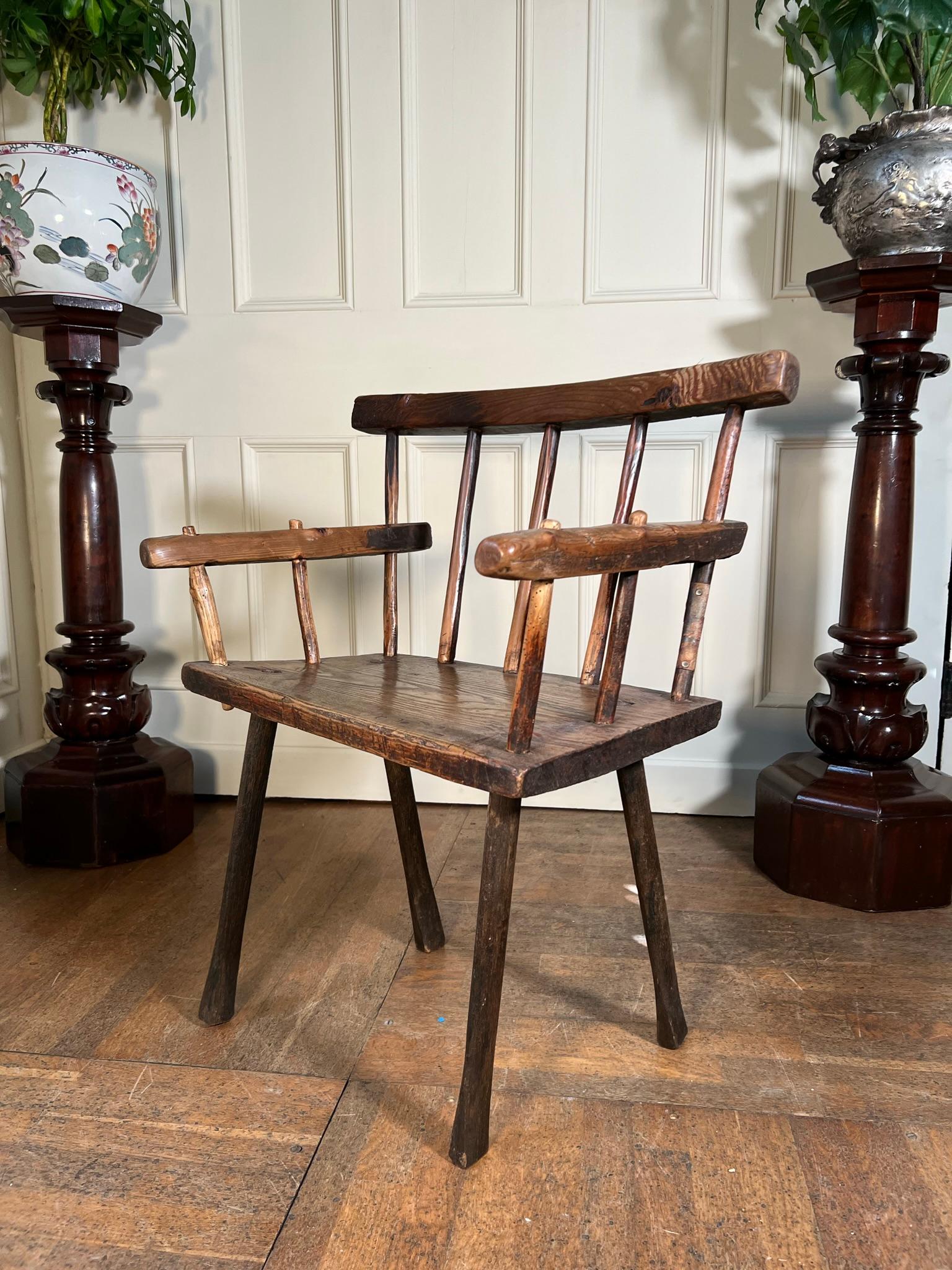 Irish vernacular at its best.

19th century chair, constructed by a hedge carpenter using any timbers available to hand.

Remnants of original red and black paint.

Legs are later but still have age and would have been replaced due to wear or