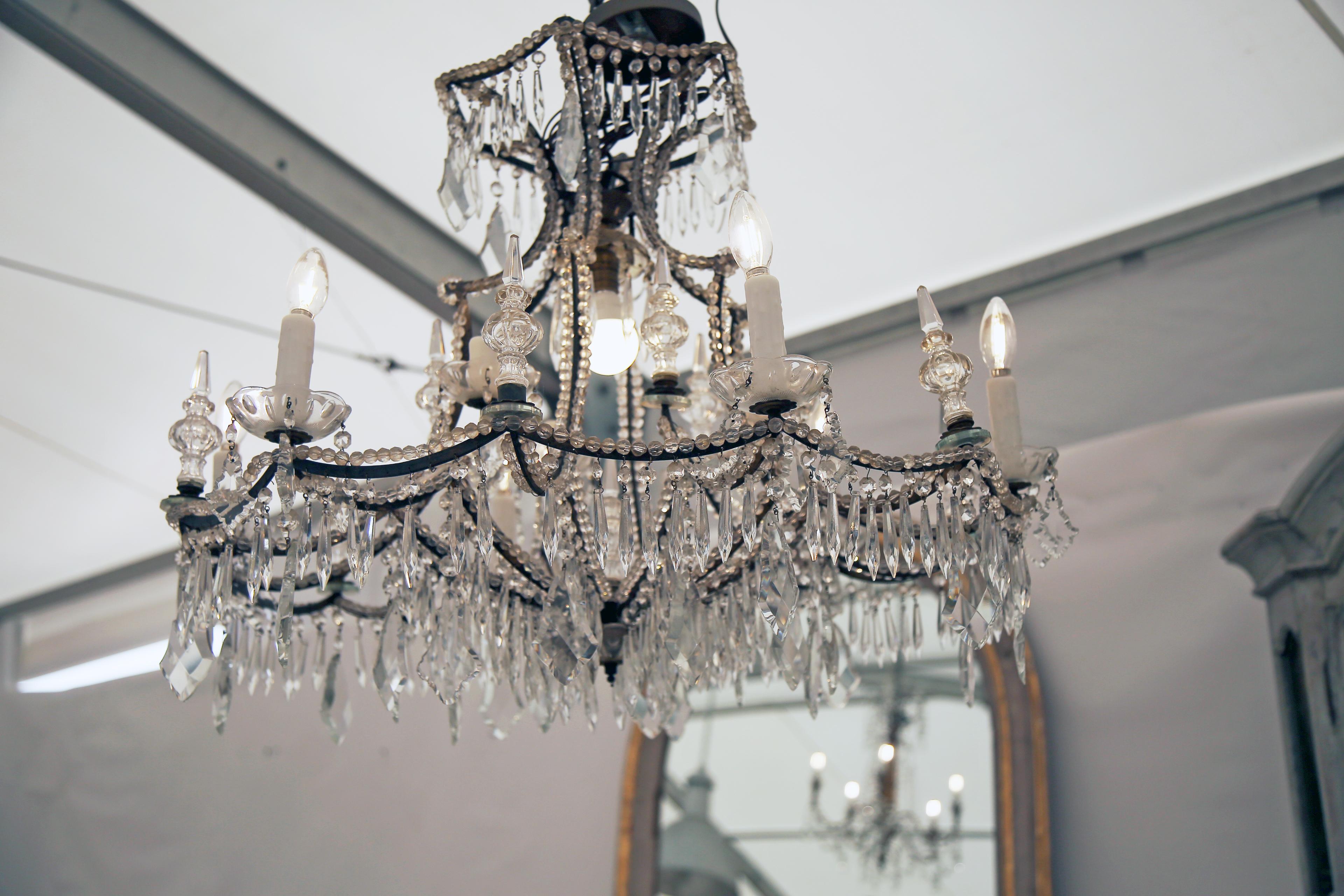 Absolute stunning and unique Italian crystal and iron chandelier. Recently rewired for US standards. We have added a plug on the end to showcase in a showroom. Electrician can remove for wiring into a home. Gorgeous and unique and is ready for it's
