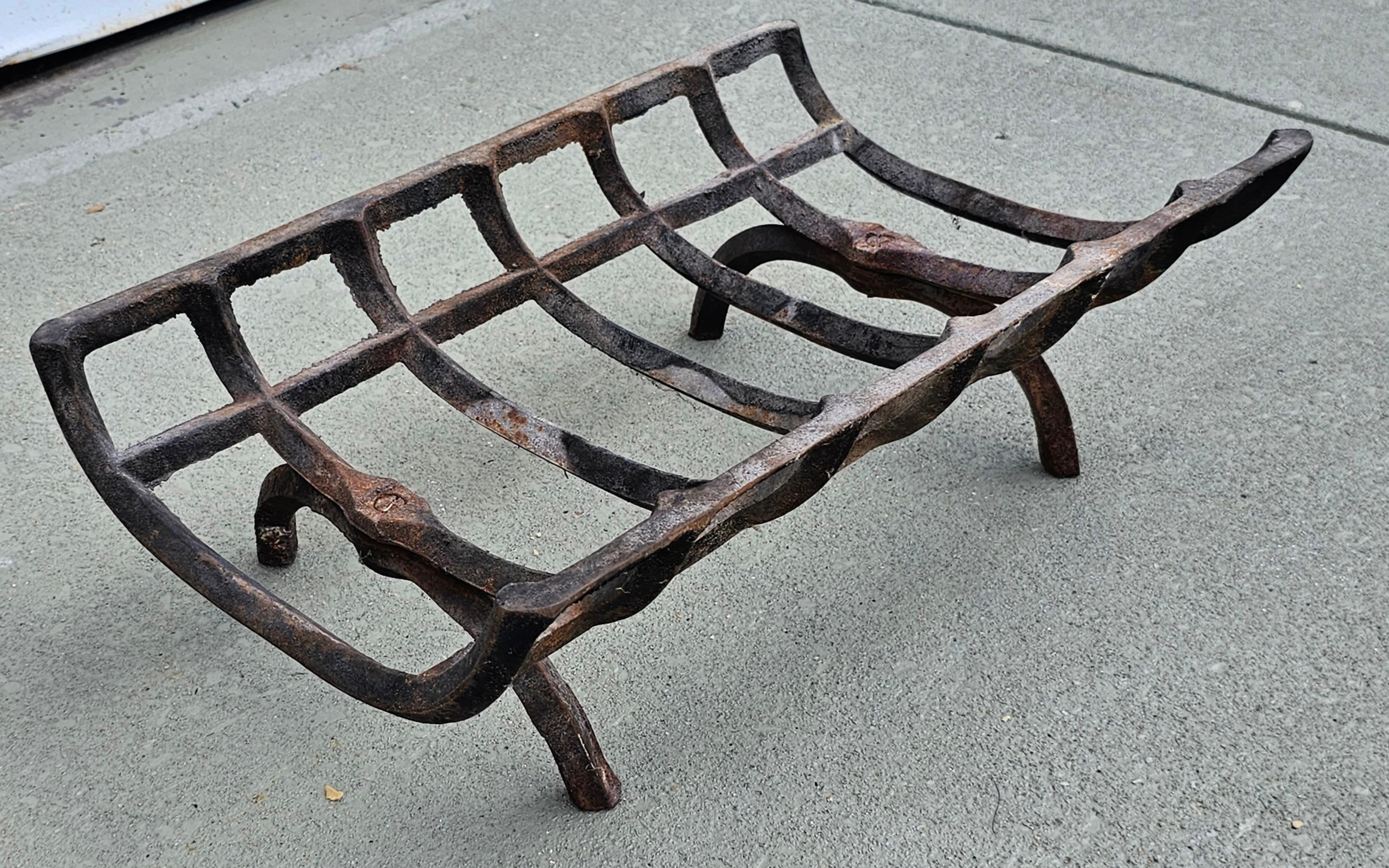 A 19th Century Patinated Iron Fireplace Log Holder Grate.
 Measures 24