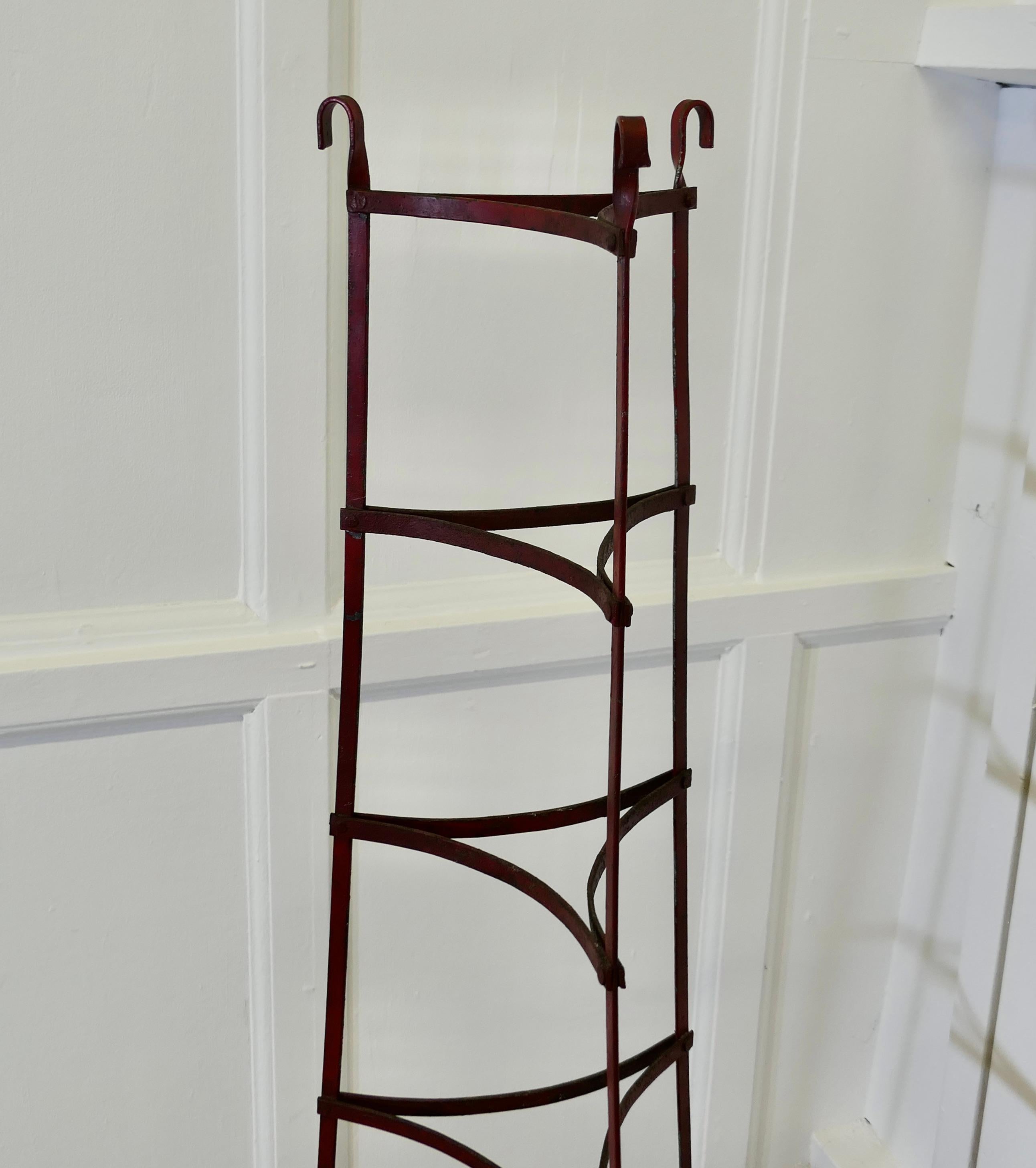 19th Century Iron Pot Stand, Farmhouse Kitchen

This is an original wrought iron hand made piece, it stands on 3 legs which curl over at the ends, the pot shelves are triangular. There are 6 pot rests in all
This is a good piece in good condition,