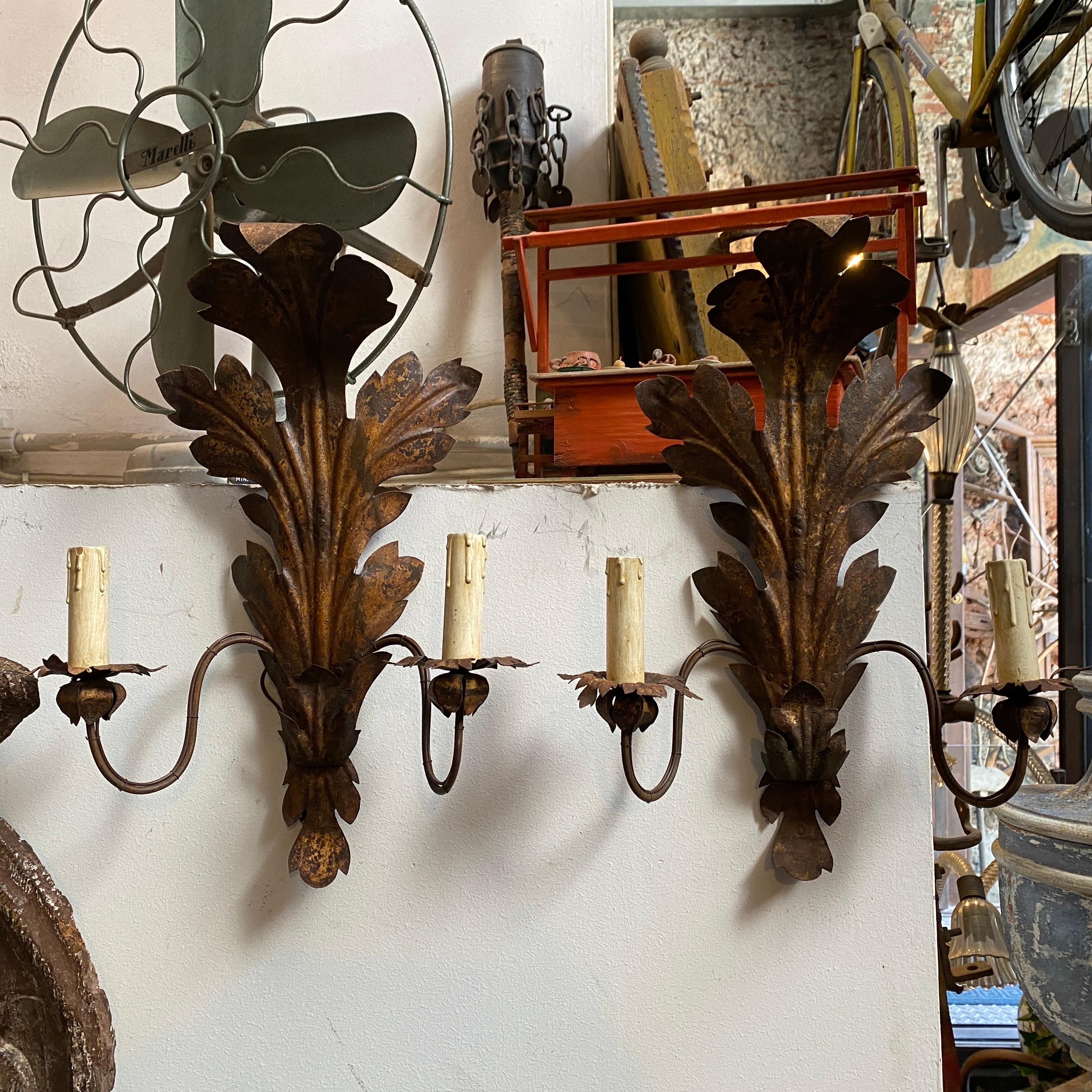 Two antique iron candle sconces hand-crafted in Sicily in the 19th century, they have been electrified in 20th century, the iron part it's in original patina and condition.