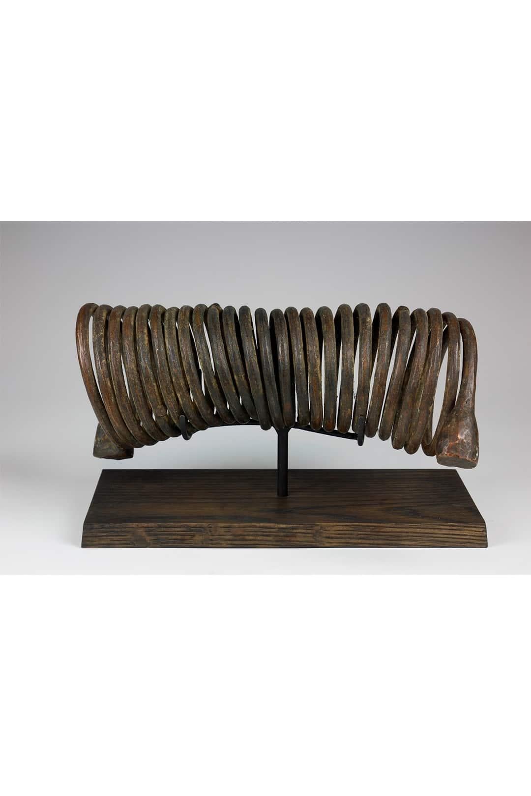 This nineteenth-century spiral currency (Manilla), from the Igbo culture in Nigeria, is impressive in its size and exhibits a wonderfully exaggerated twisted, spiral form.

Spiral iron currencies of various shapes and forms were traded throughout