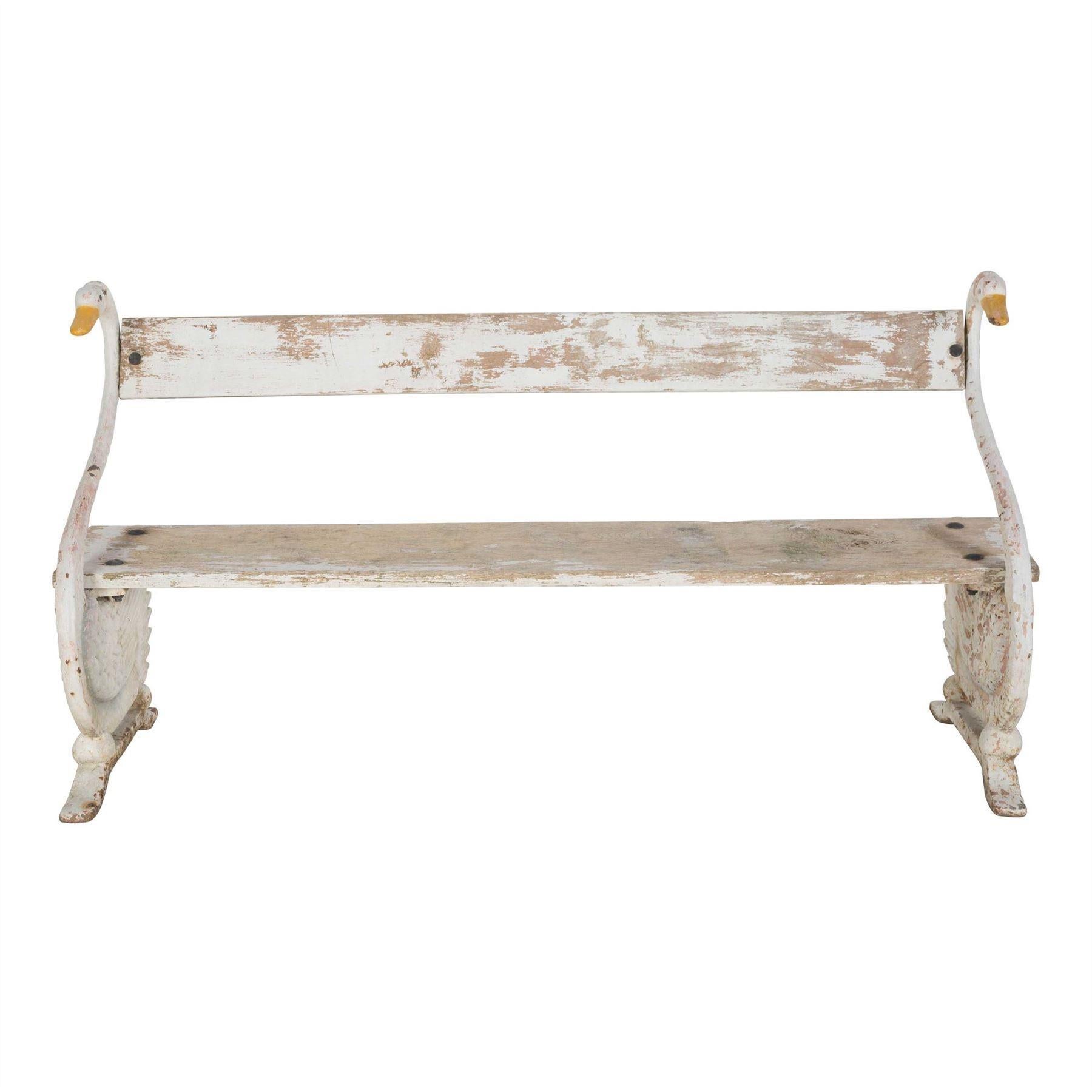 A 19th century French garden bench, circa 1880.

The original oak seat and backrest are supported by a pair of iron swans in their original paint.

Wonderful patina to both the wood and the paint on the swans. Very strong and sturdy condition to