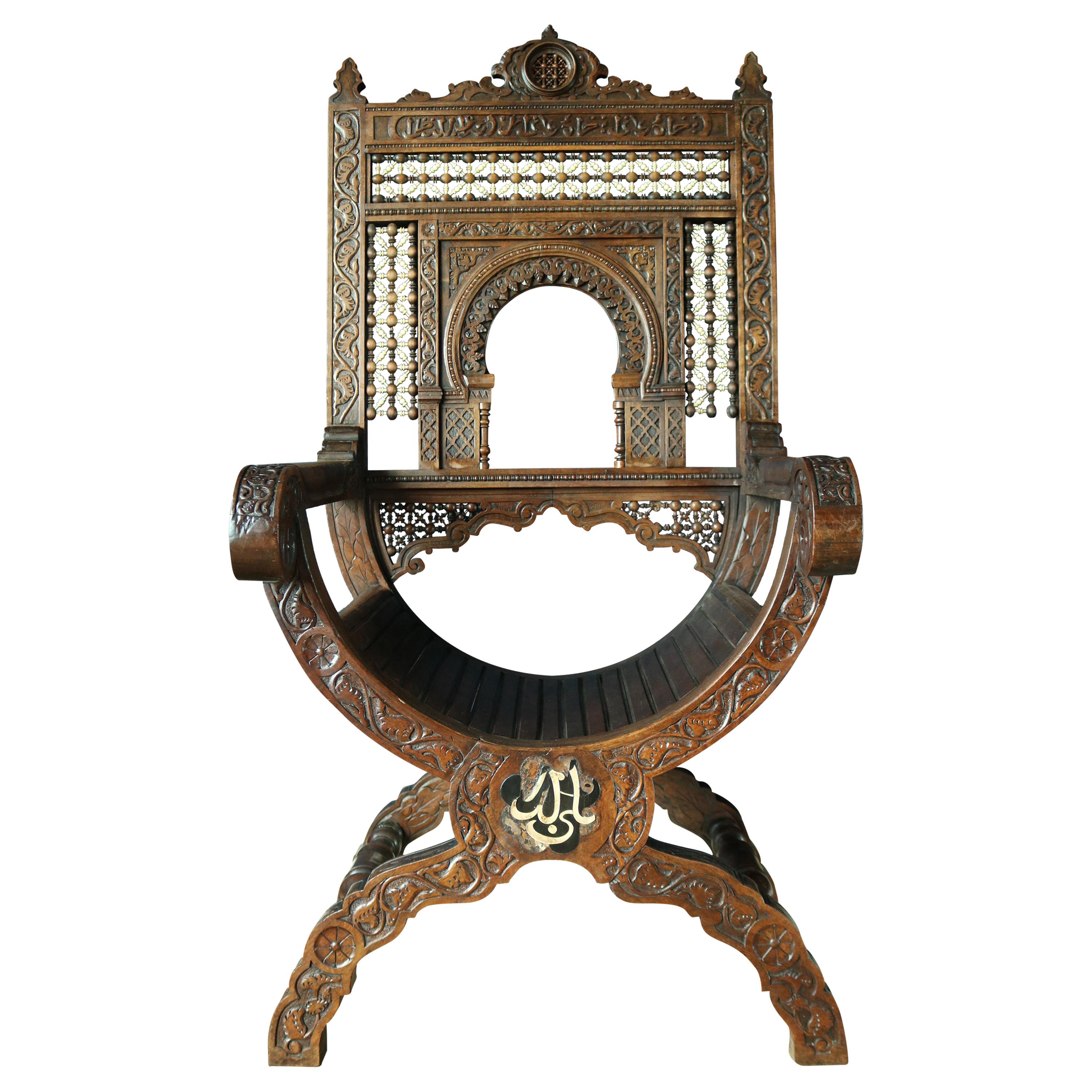 A exceptional 19th century Islamic armchair in the Morrish style probably from Damascus in Syria, beautifully carved with areas of Islamic script and on the back of the chair beautifully turned bone decoration, the chair is in remarkably good