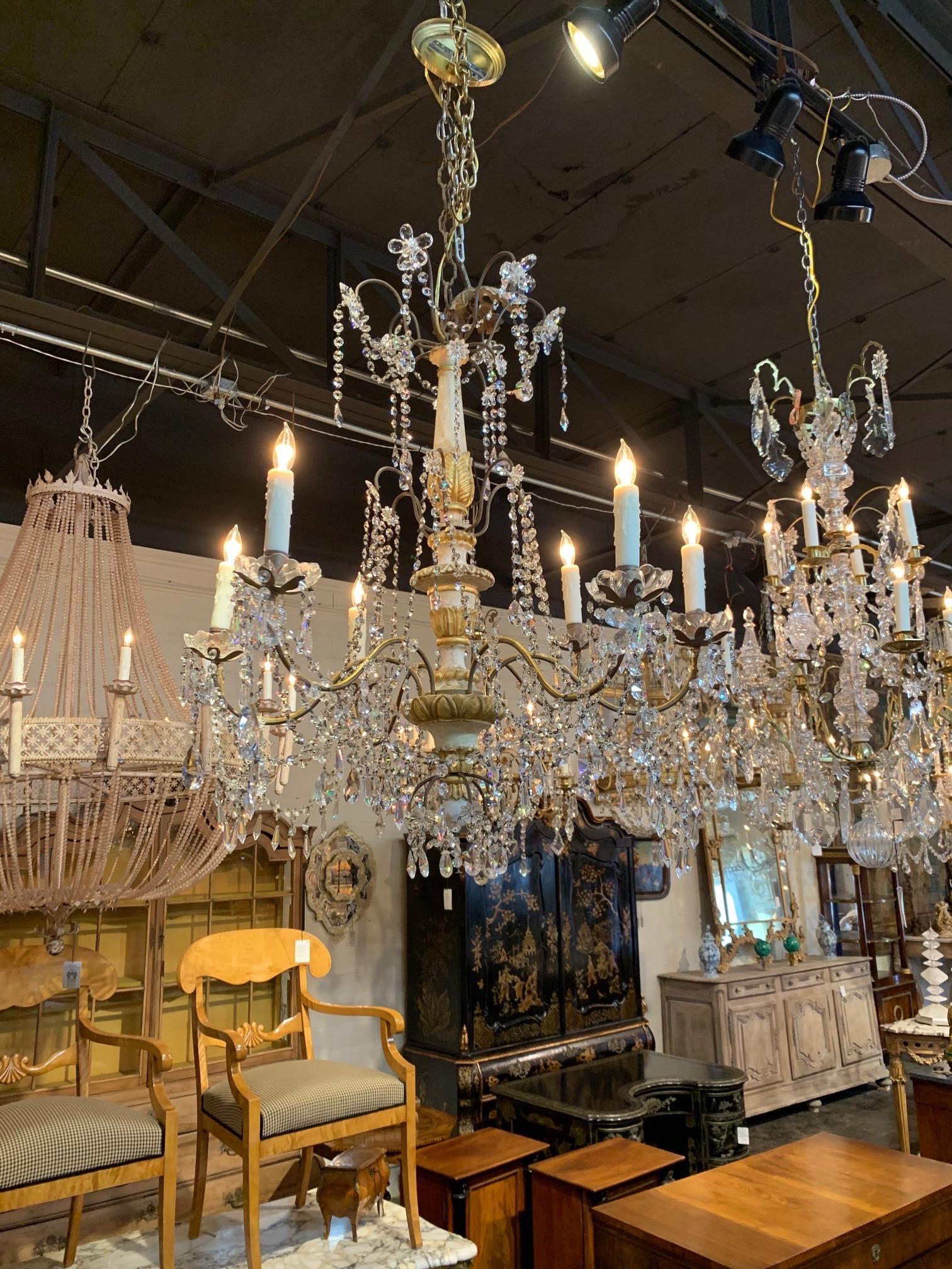 Elegant 19th century Italian parcel-gilt wood and crystal chandelier with 6-light. Base is painted in white and gold gilt with pretty carvings. The fixture also have an abundance of beautiful crystals. Gorgeous!