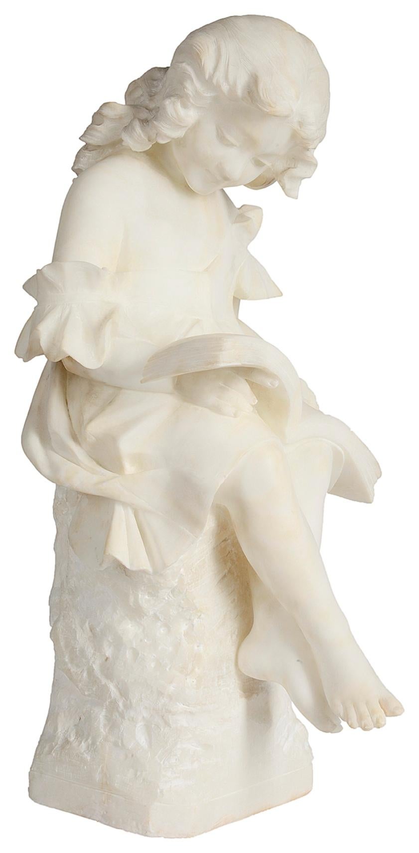 A very good quality 19th century Italian carved alabaster study of a young girl seated, reading a book.