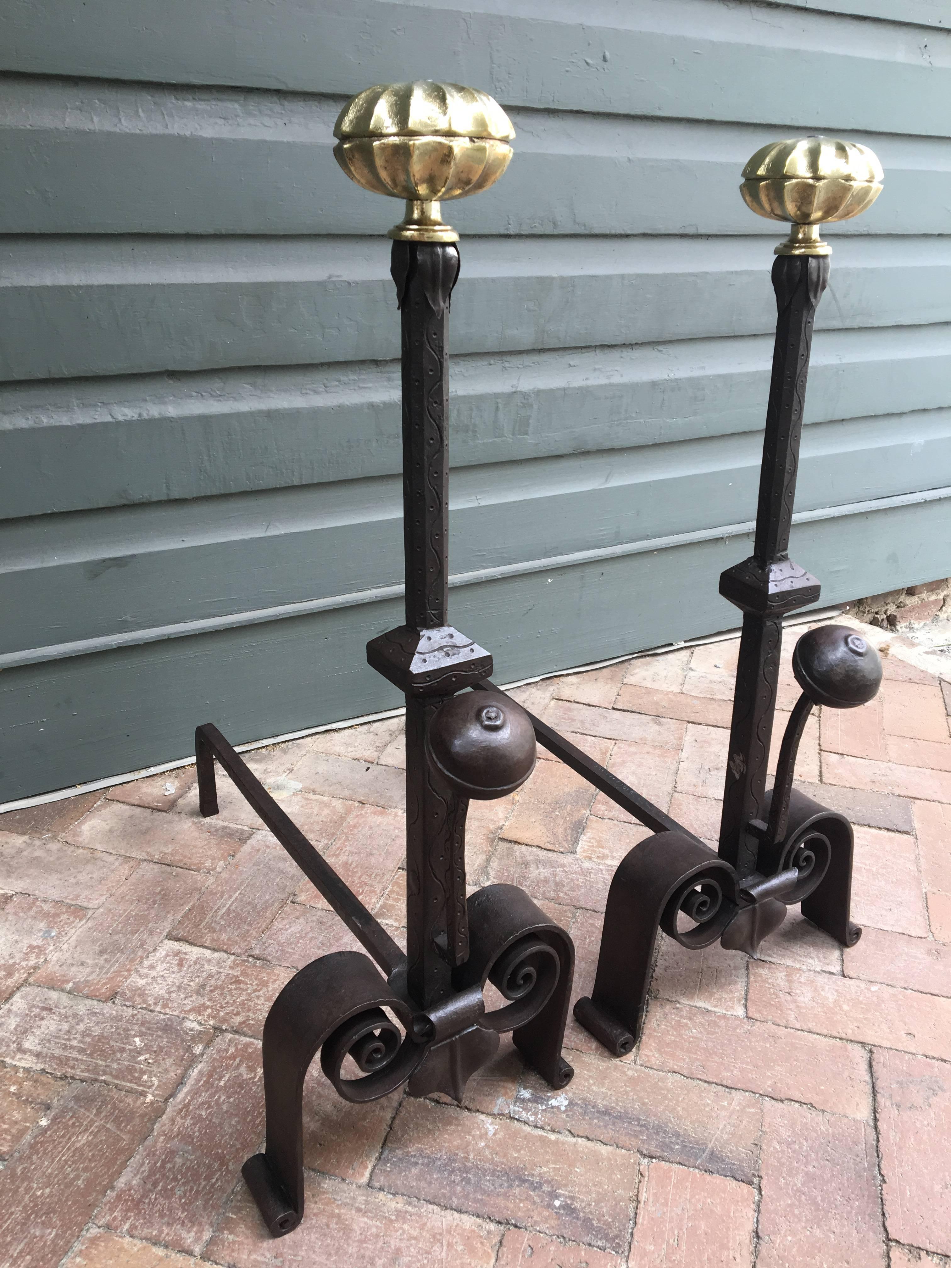These 19th century Italian andirons have hand wrought engraved centre pedestals ending in scroll stylized legs. The melon tops are cast brass.