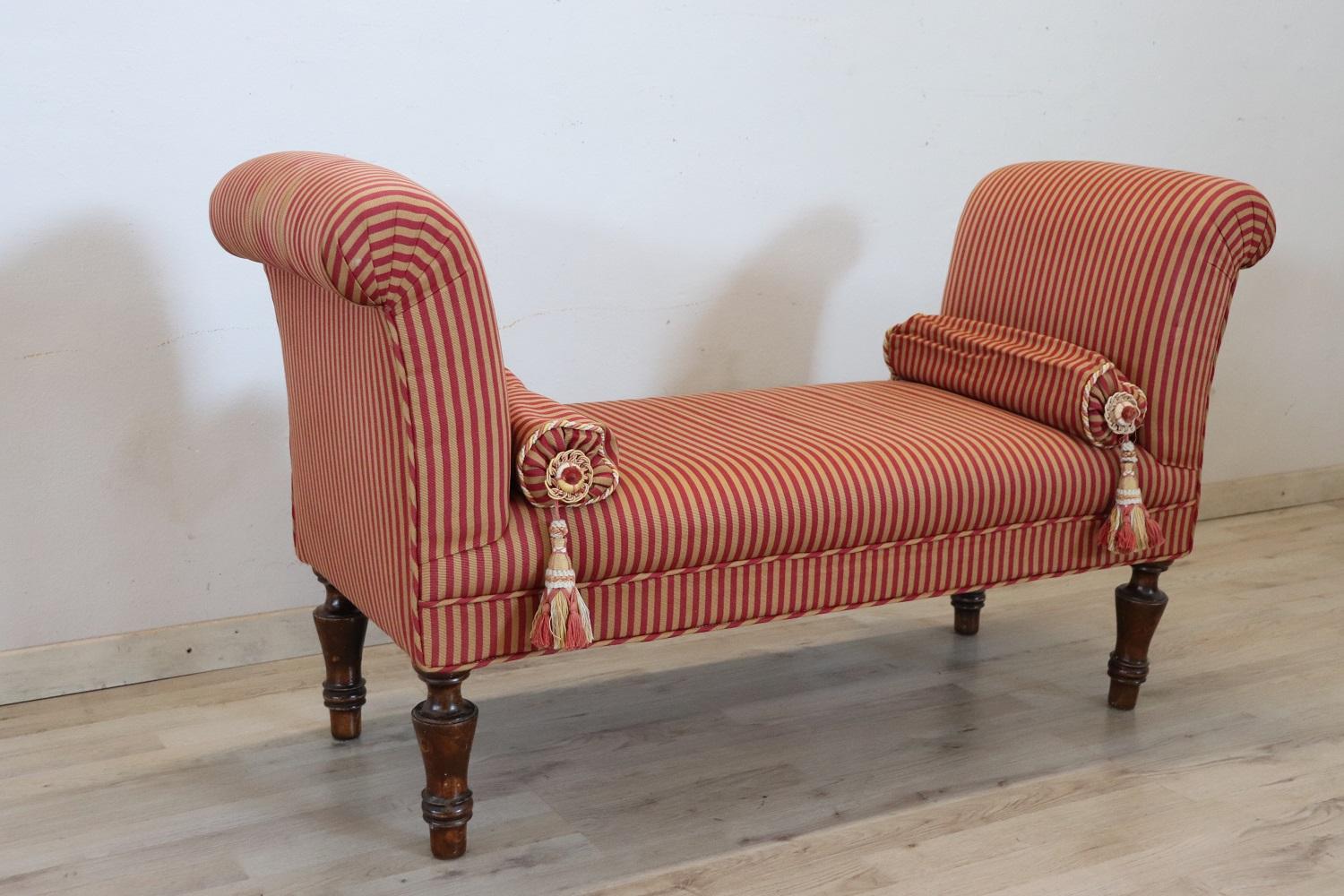 19th century antique italian bench, truly refined, fully padded and covered in elegant red striped fabric. The turned feet are in solid beech wood. Finished on each side, it can also be positioned in the center of the room. Perfect for embellishing