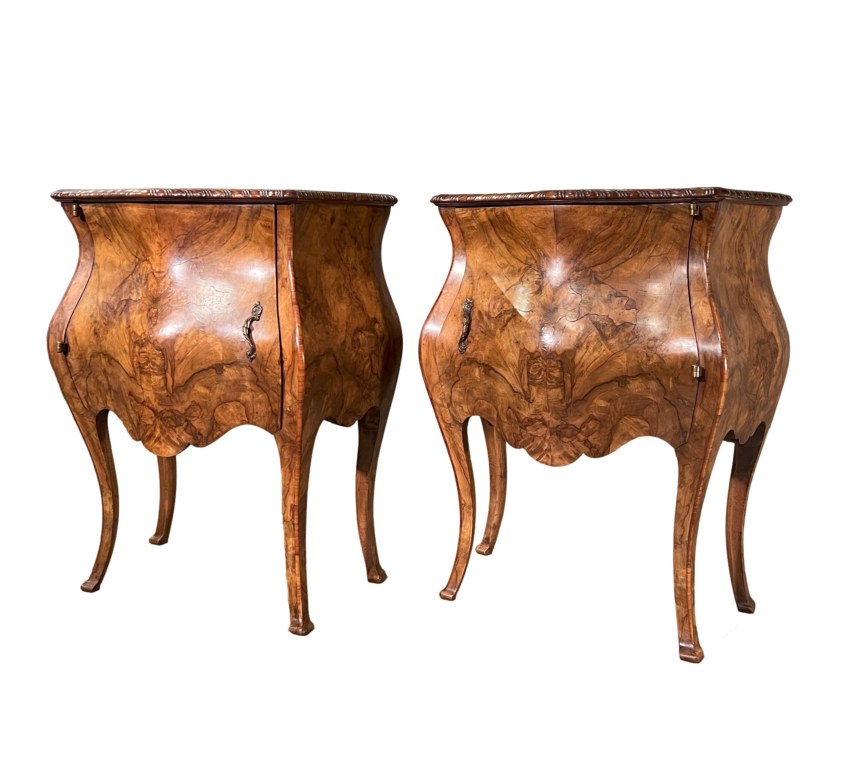 These Italian Antique Bombe Louis XV Style Venetian Pair of Night Stands are wonderfully crafted pieces that will add a wonderful visual appeal to any space they are added to. The pieces are crafted from aged walnut veneer and are beautifully