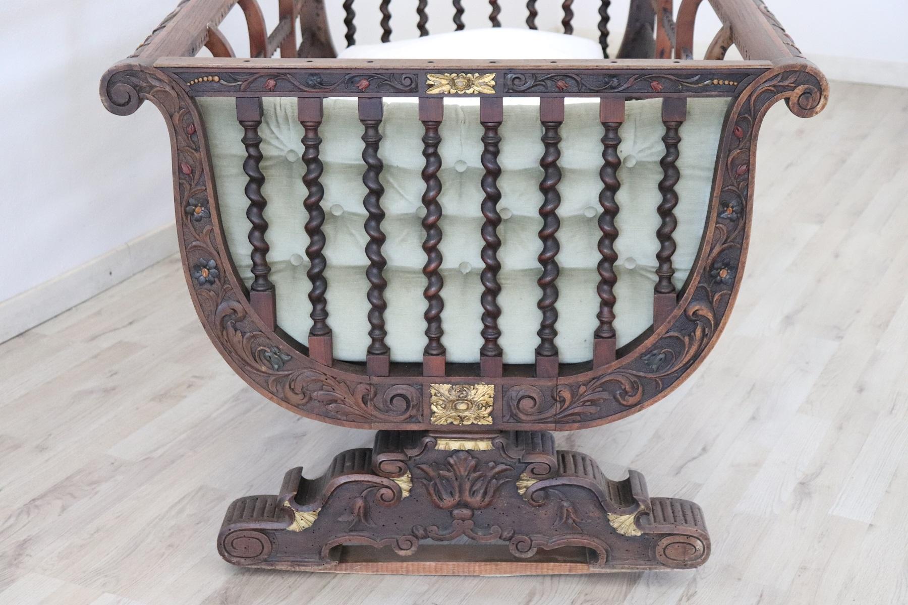 Rare antique crib for children or cot 1880s. Made of solid walnut wood with refined workmanship. Walnut wood has turned columns along each side of the cradle. On the edges refined decorations with carving of floral taste. Some decorations are