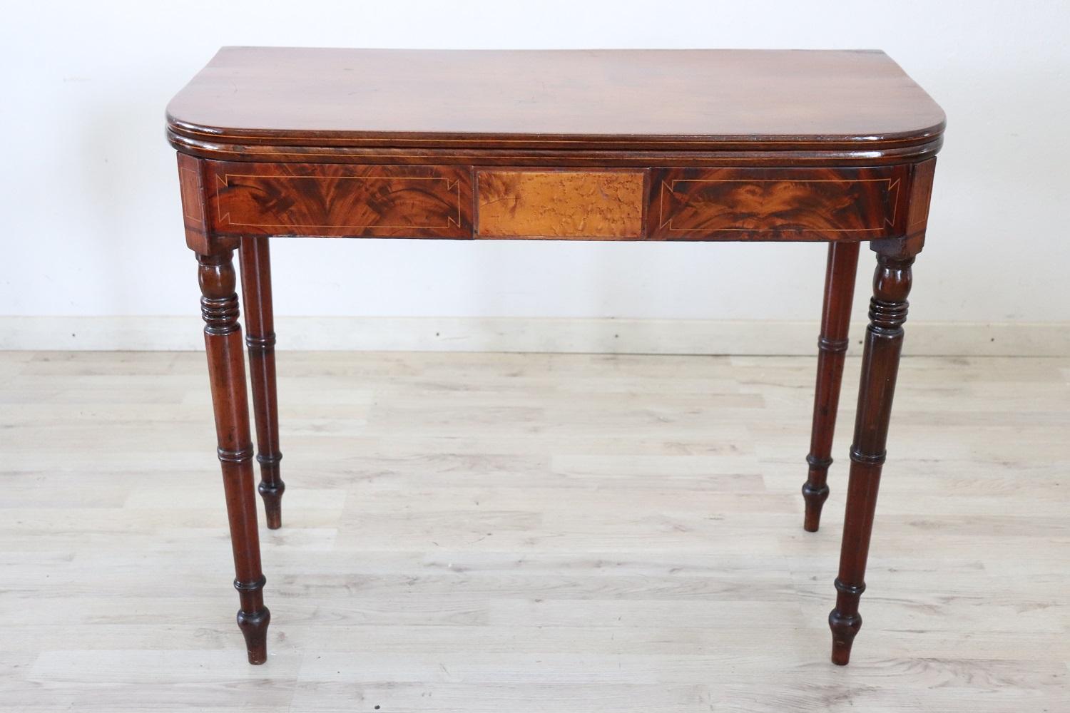 Beautiful very nice Italian solid walnut wood antique console table, 1850s. The table is very simple and linear, characterized by solid turned legs. The top of this table opens like a book page and doubles in size. The dimensions of the top when it