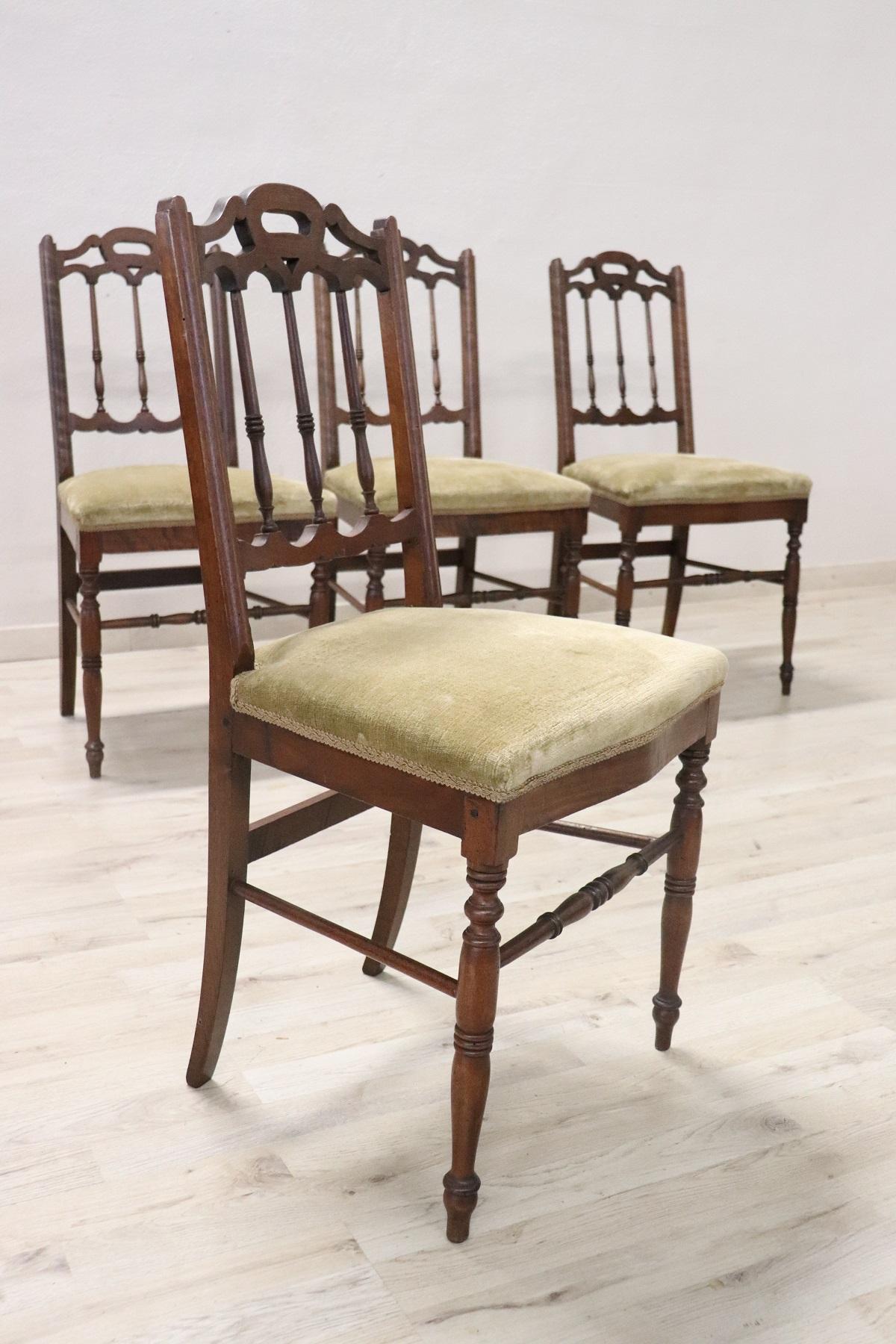 Series of refined Italian four chairs in solid walnut wood. The walnut wood with refined turned decoration in the back and legs. The legs are very elegant. The seat is wide and comfortable with velvet. The chairs are used but good conditions. Please