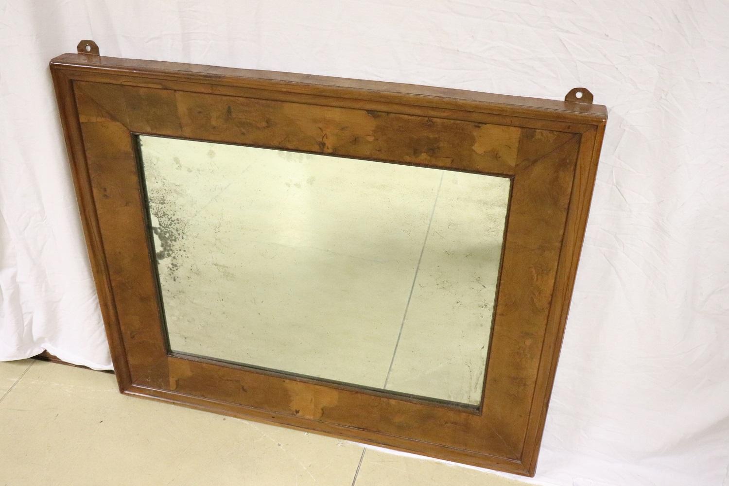 19th century Italian large wall mirror circa 1880s. The wooden frame is in precious walnut briar. The mirror is antique to mercury so it presents imperfections look good at the photos. Elegant in every room of your home.
 