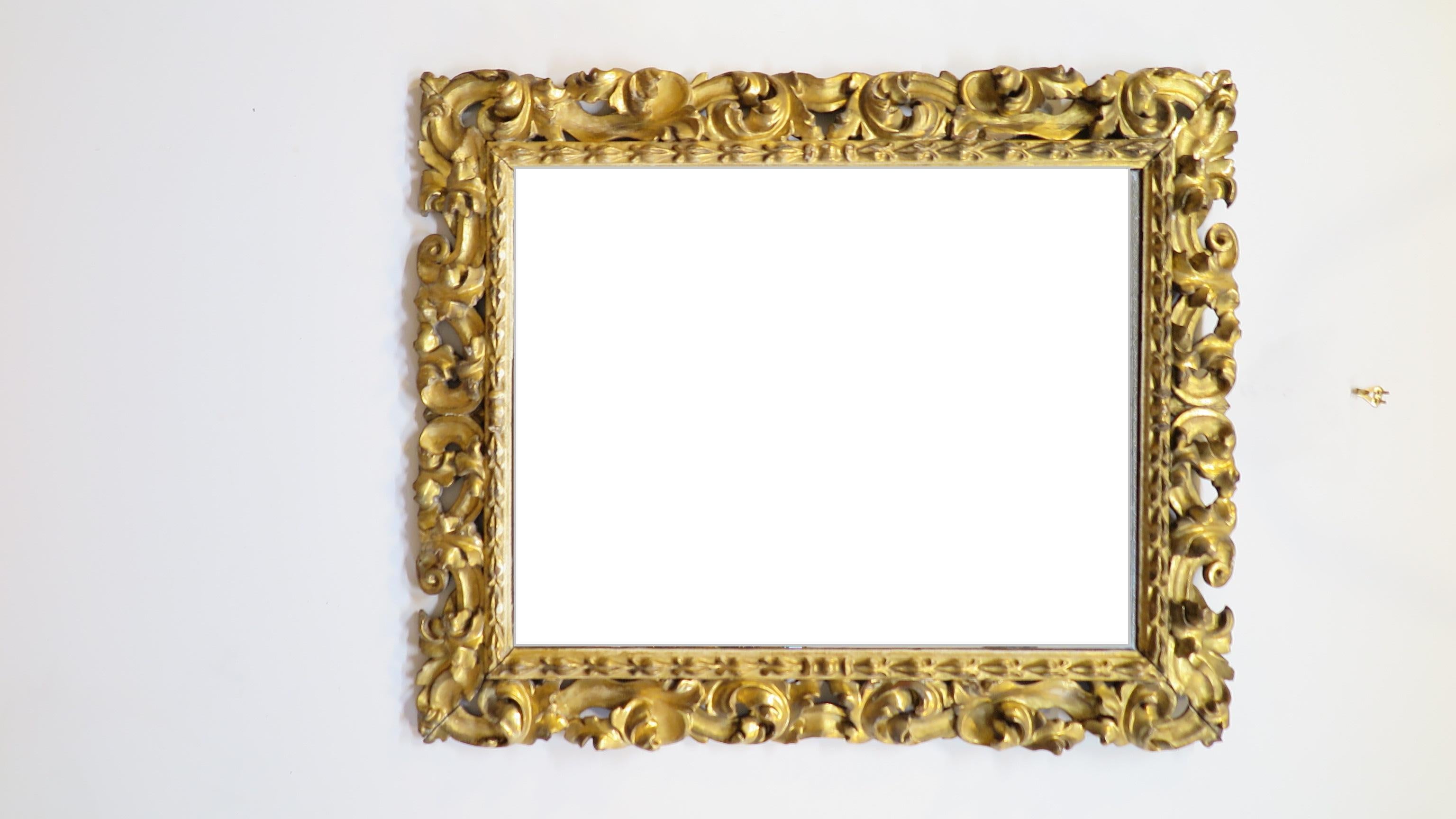 Italian 19th century baroque hand carved mirror. Hand carved of solid wood from the middle 19th century having Gesso and gold leaf. Acanthus leaf carving adorns the mirror frame. Glass and mirror affect are clear with good reflection. Some age spots