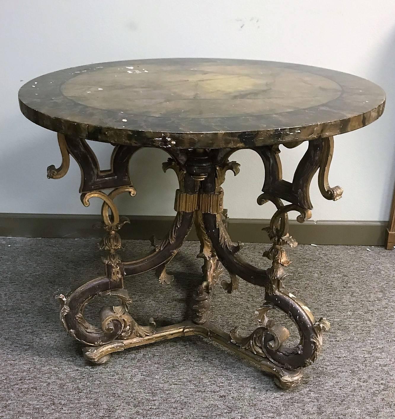 Outstanding 19th century Italian Baroque centre table with a faux marble top. The parcel giltwood pedestal base ornately carved and reticulated with geometric and free-flowing open designs with scrolling leaves and stylized tassels,

circa