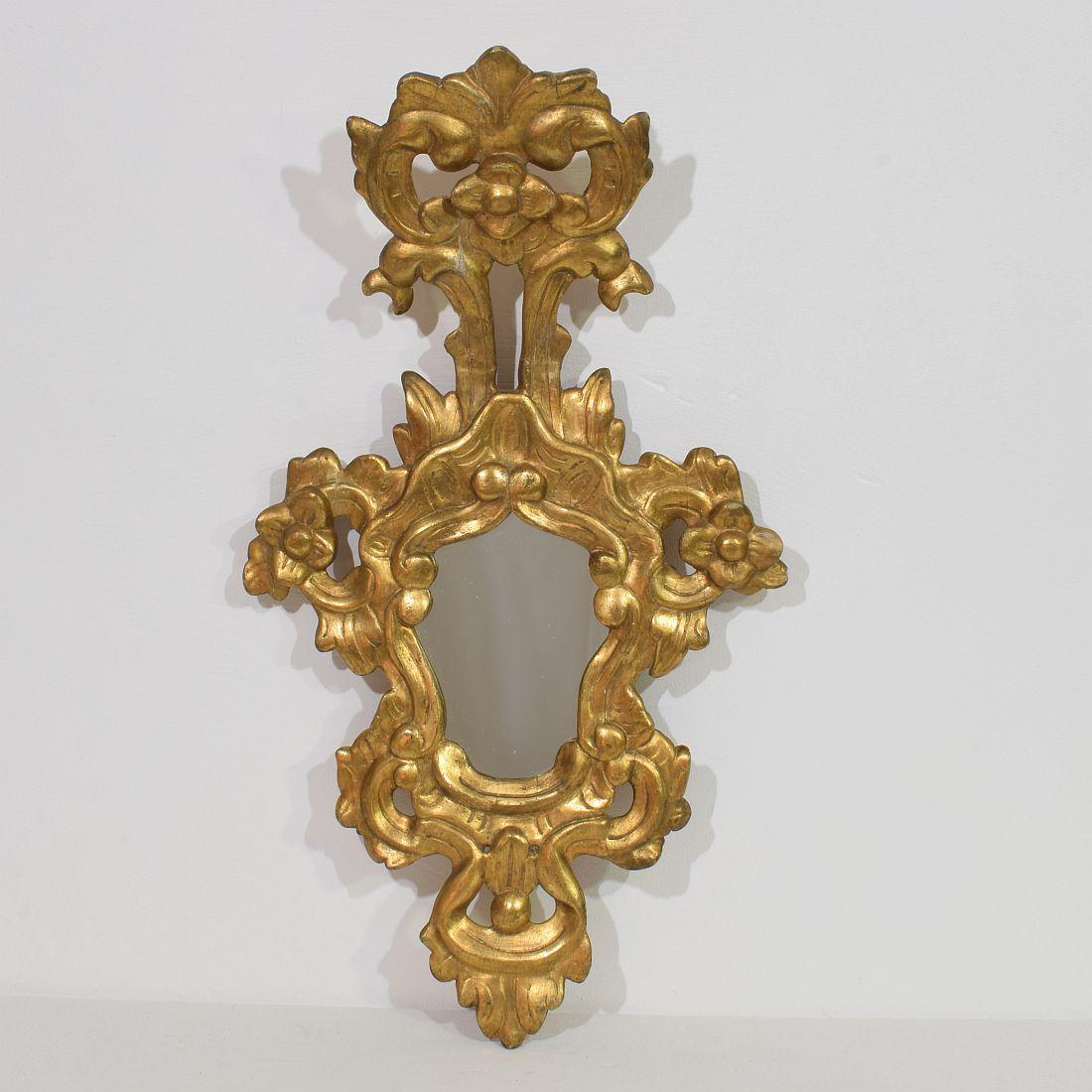 Wonderful Baroque style giltwood mirror, Italy, circa 1850. 
Weathered, small losses and old repairs.
