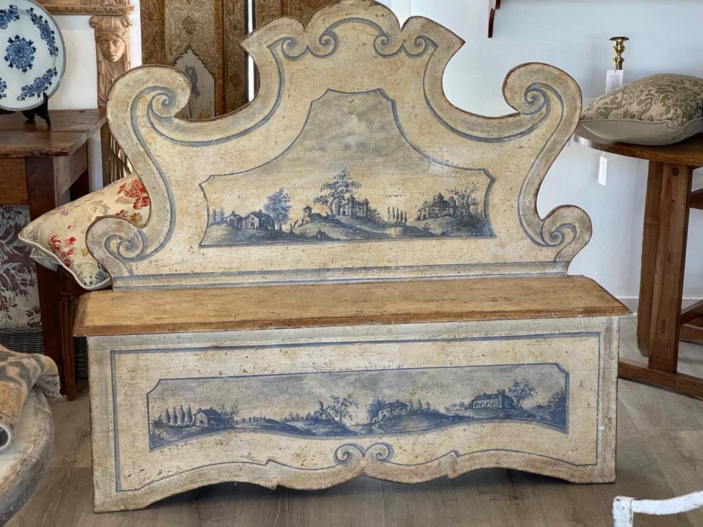 19th Century Italian Baroque style Tuscan hall bench of cassapanca form, the scrolling seat back above a molded seat and base with a formed skirt, painted in pale yellows and blues with Tuscan landscape scenes. Found north of Florence. 

