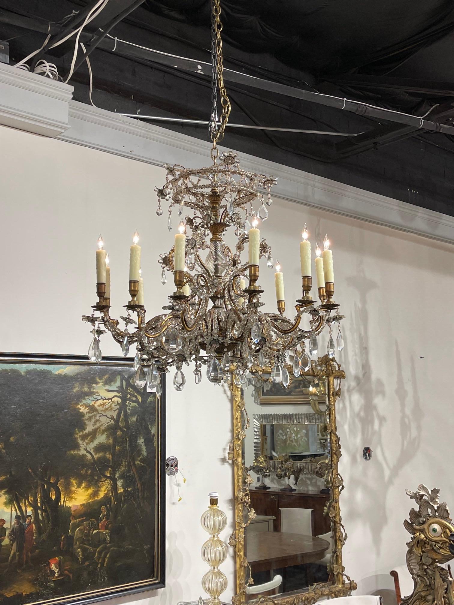 Elegant 19th century Italian beaded crystal and gilt bronze chandelier with 12 lights. Pretty curved base covered in beads and crystal. Makes an impressive statement!!