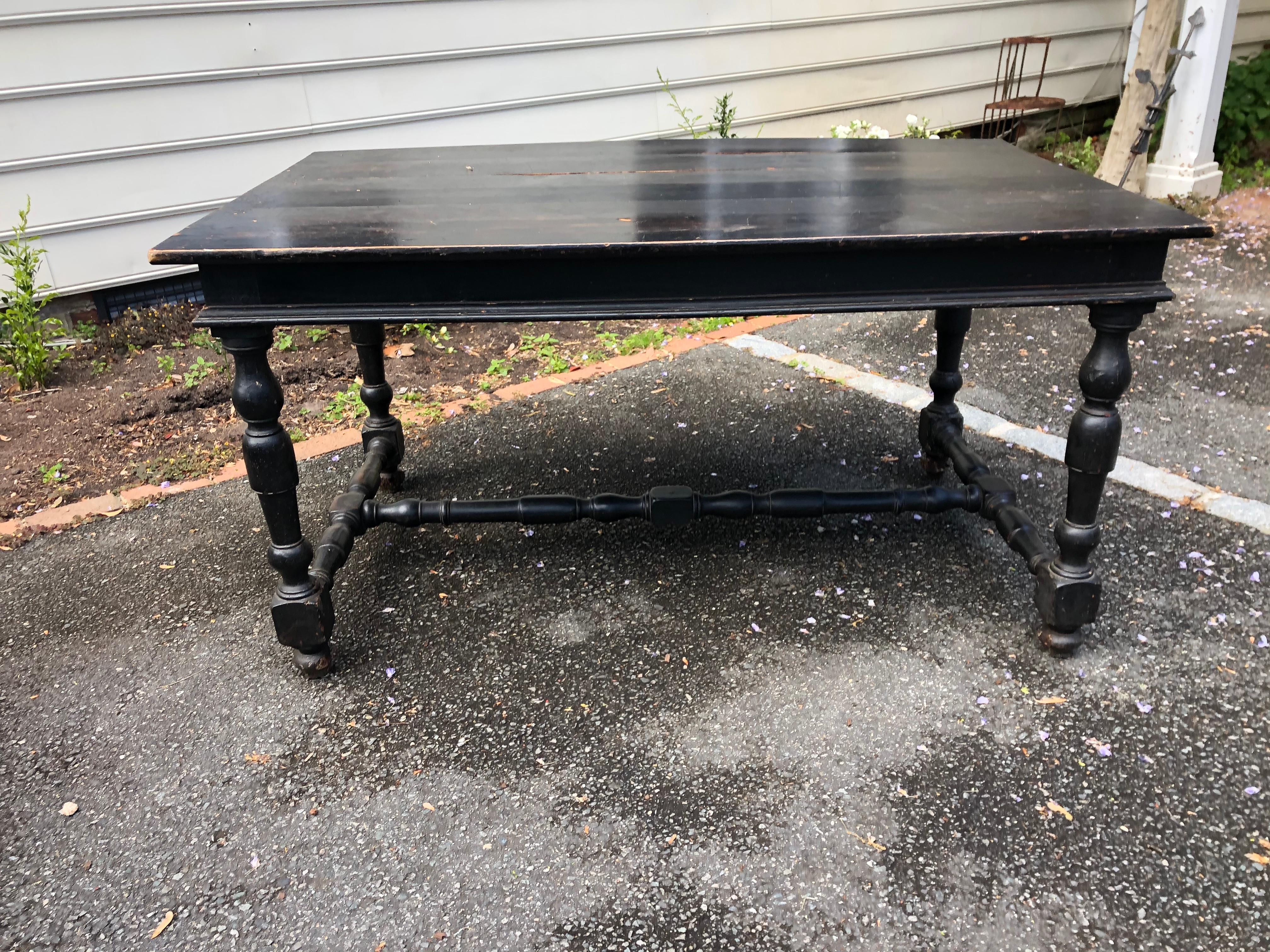 19th century Italian black painted table with turned legs and stretcher.