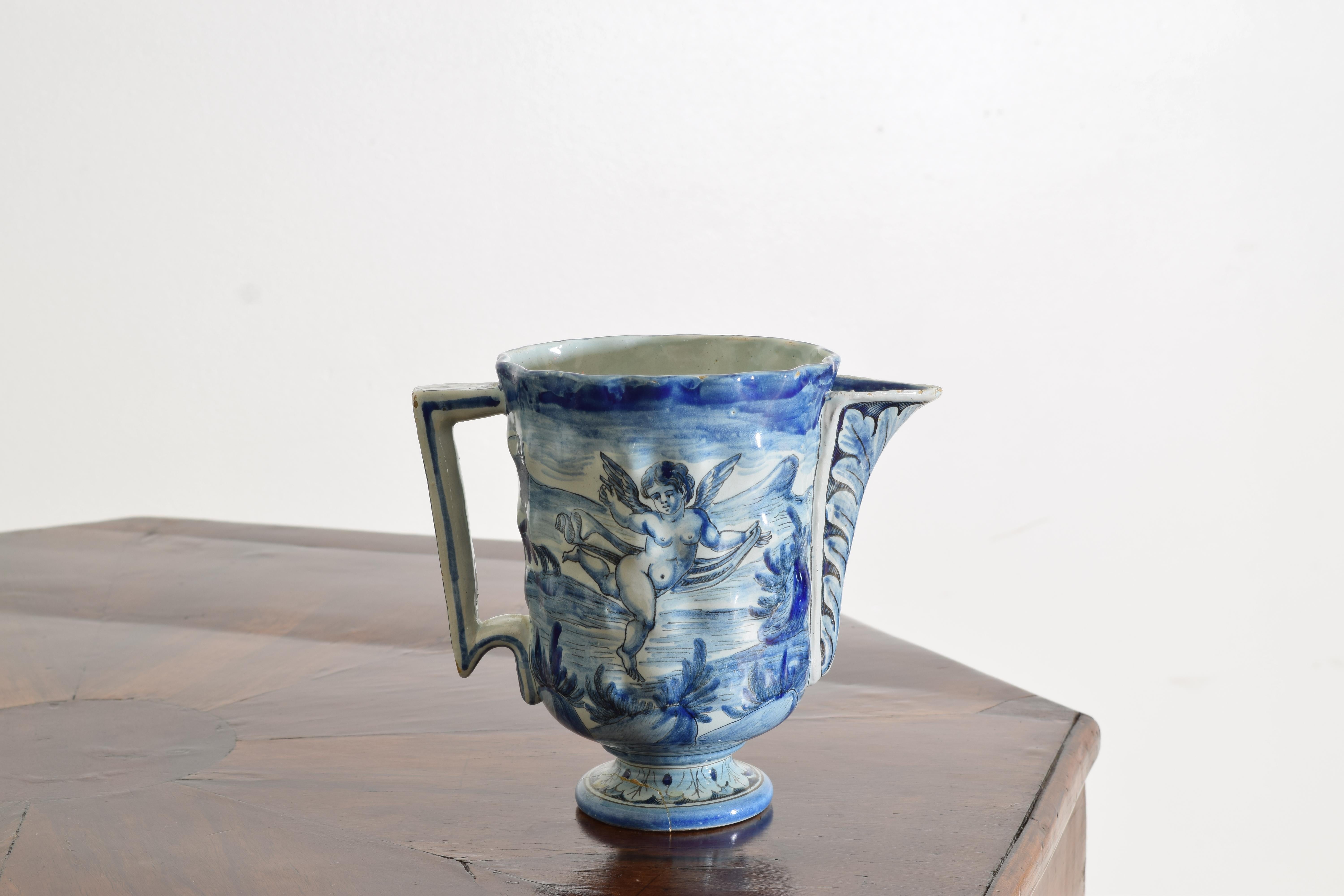 19th century, blue and white painted on one side with a cupid and on the opposite side painted with a village scene, the underside marked with a rooster for Cantagalli Italian majolica.