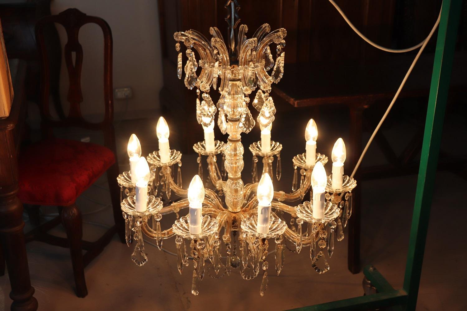 Beautiful and refined Italian circa 1880s chandelier ten lights. In bronze and completely covered drops of crystal. The crystal exudes the typical brightness; the drops are finely worked giving an elegant light. Chandelier of refined elegance and