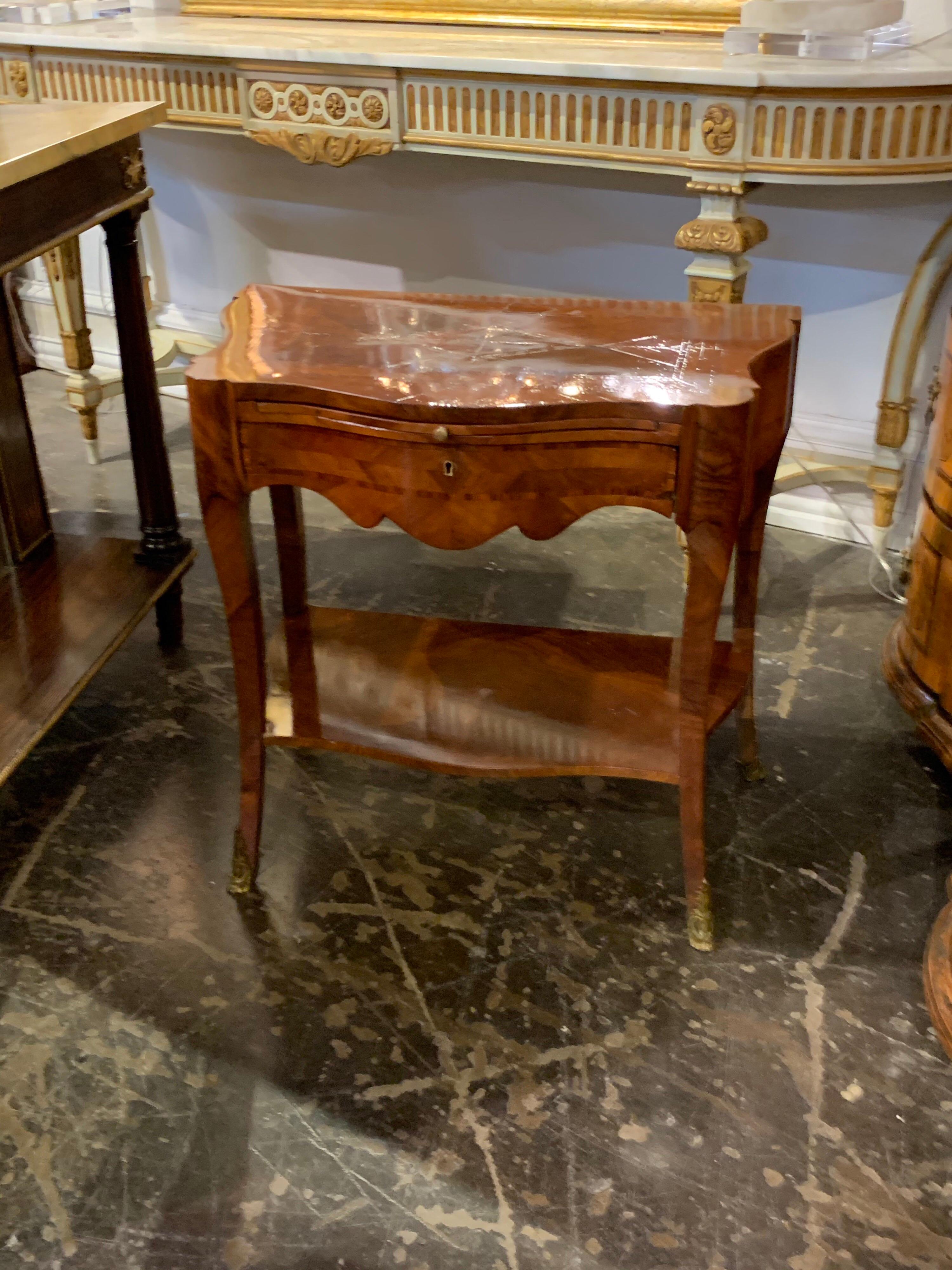 Lovely 19th century burl walnut one drawer side table. The table has one drawer and desk top that pulls out. Also has pretty inlaid details and a very nice finish!
