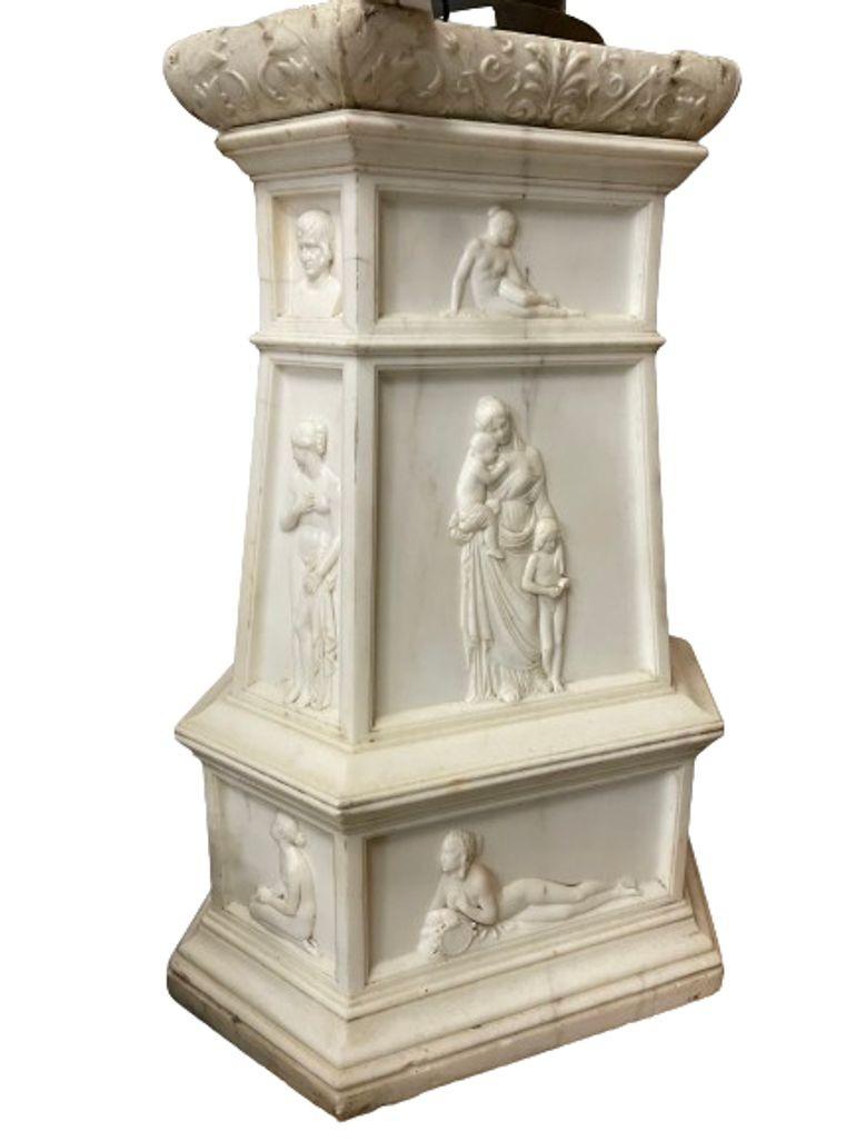19th Century Italian Carrara Marble Pedestal, Neoclassical Carvings,

A highly Unusual carved white marble hexagonal pedestal; pedestal sides decorated with differing figural relief, marble top with carved leaves direct from a Greenwich CT