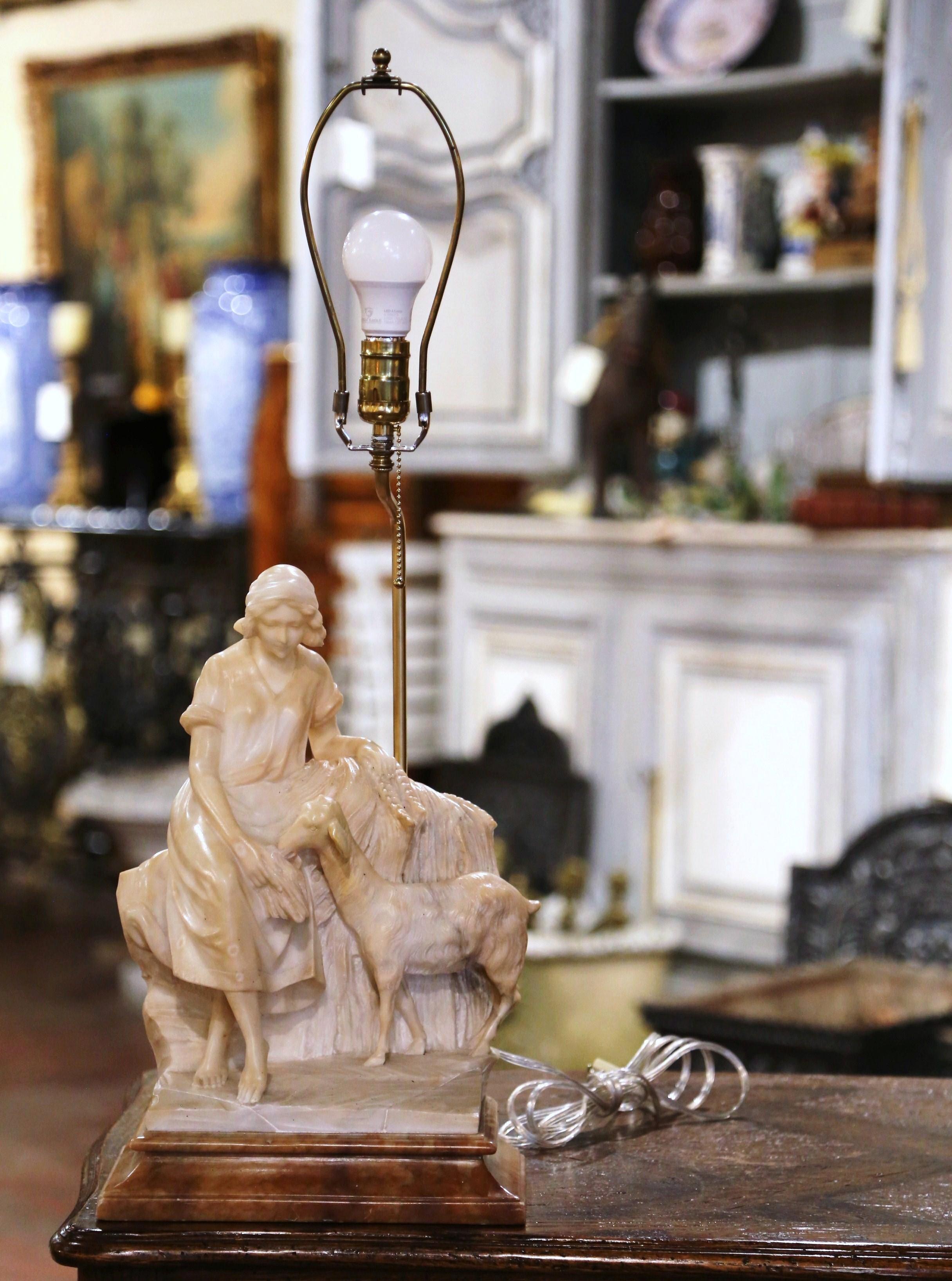 This charming antique alabaster sculpture lamp was created in Italy circa 1890. Signed on the back by R. Colivicchi, the composition depicts a beautiful scene with a young woman feeding a goat. With intricate details throughout, the carved 