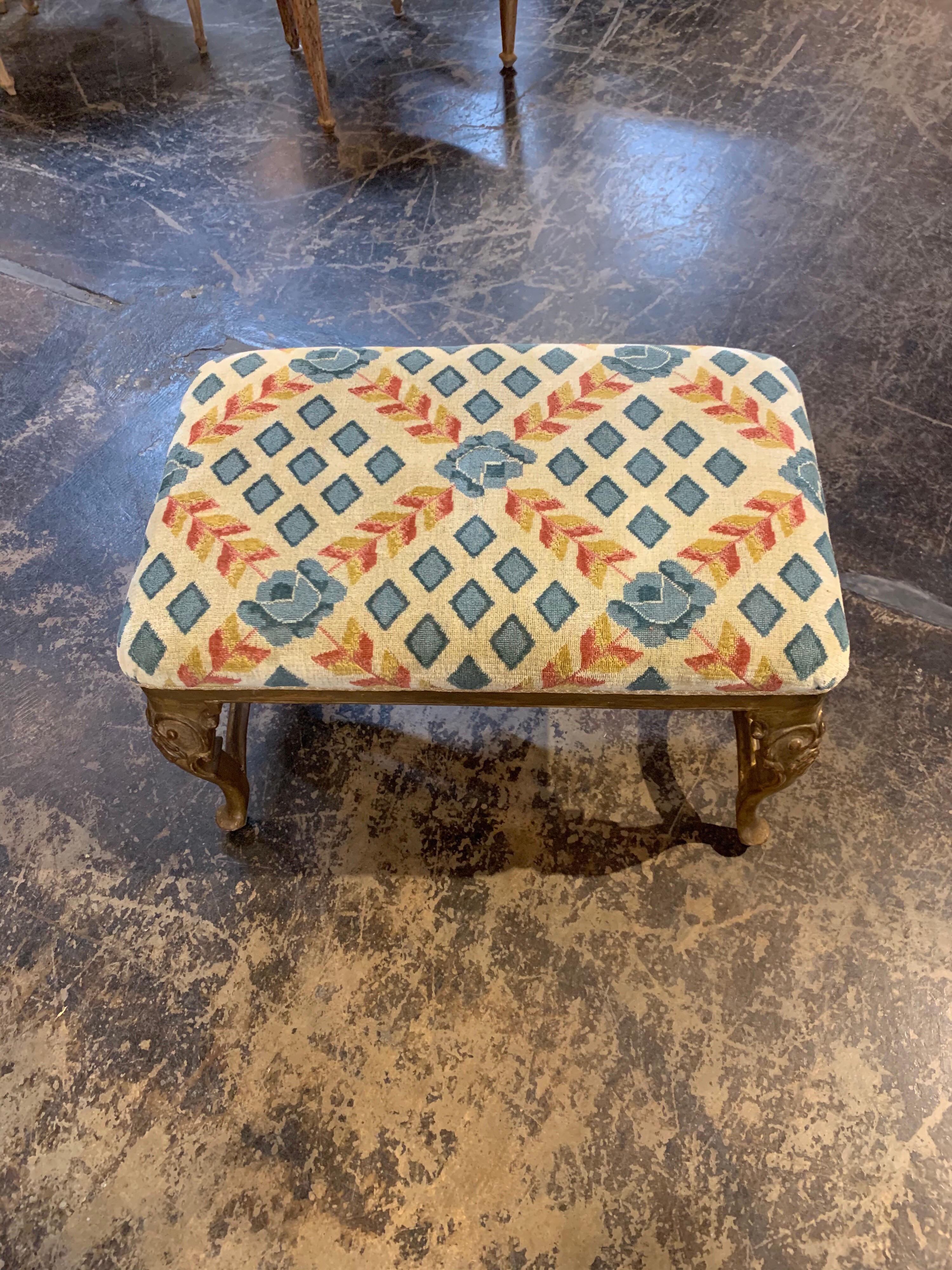 Beautiful 19th century Italian carved and giltwood bench. The piece is upholstered in a lovely fabric of light blue, orange and gold. Very nice carving and gilt on the base as well. So pretty!
