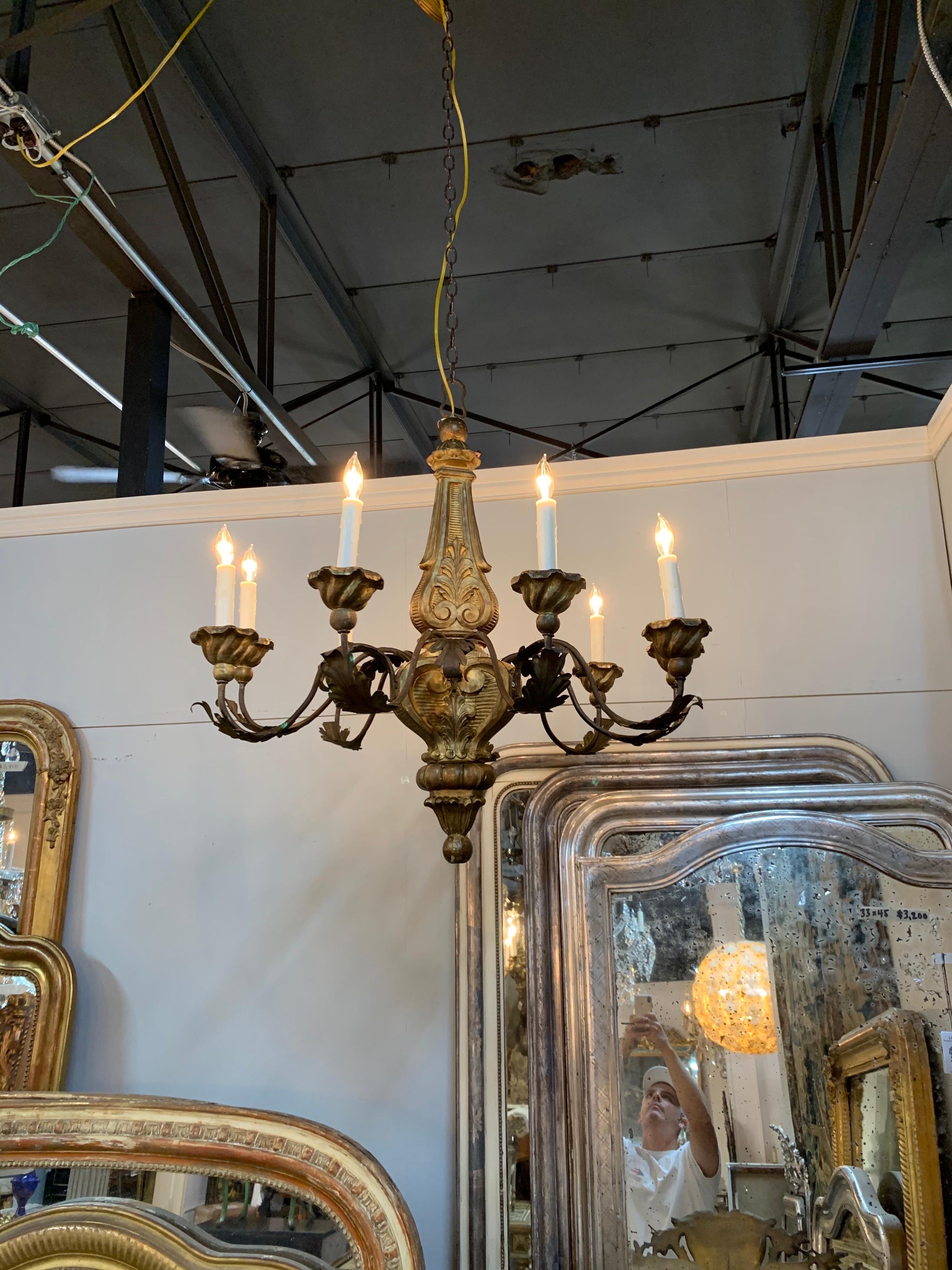 Handsome early 19th century Italian carved giltwood chandelier with 8 lights. Very pretty carvings and nice leaf pattern on the arms. Lovely!