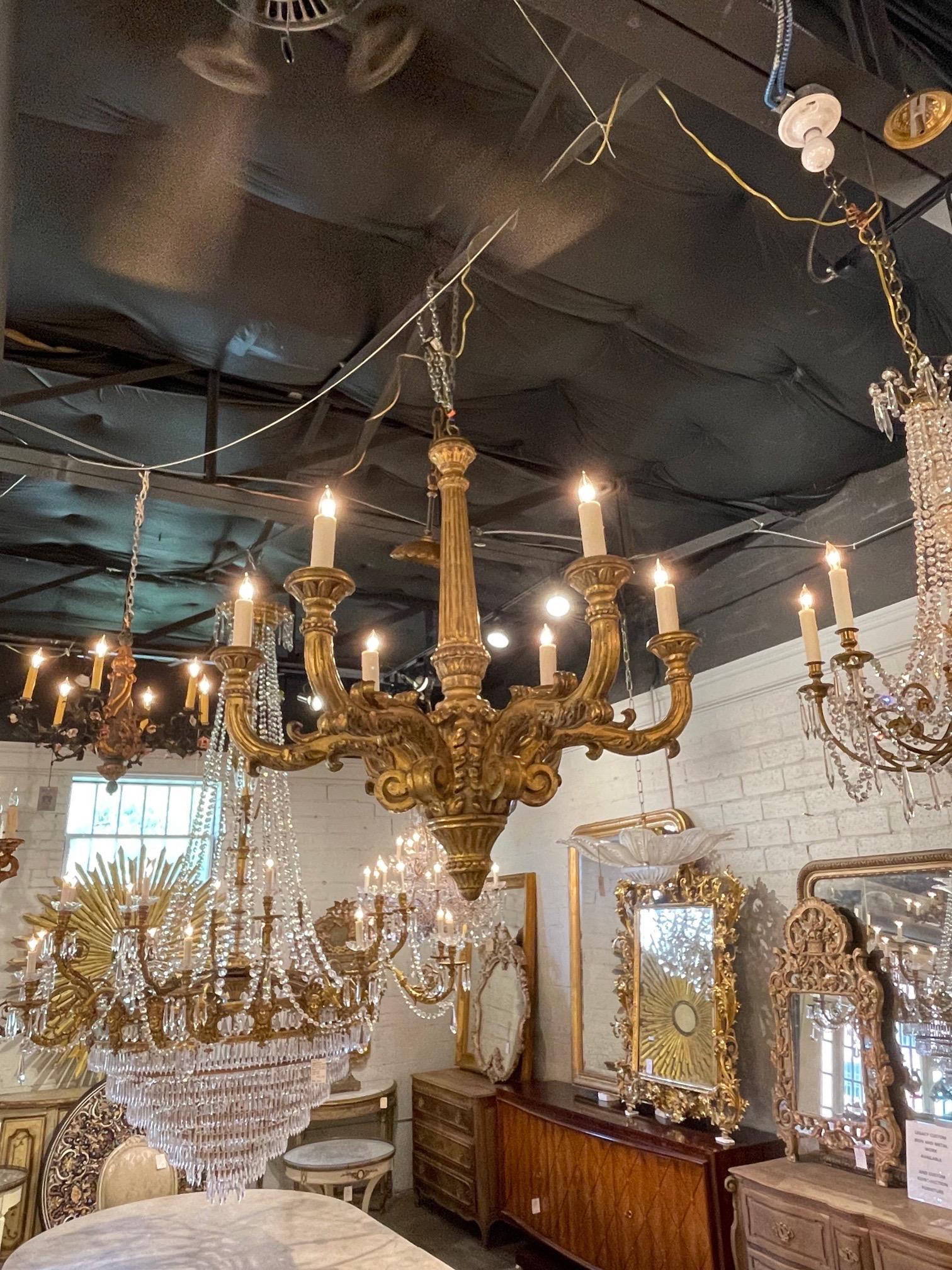 Beautiful 19th century Italian large scale carved and giltwood chandelier. The carving on this fixture are superb. Makes a very impressive statement!