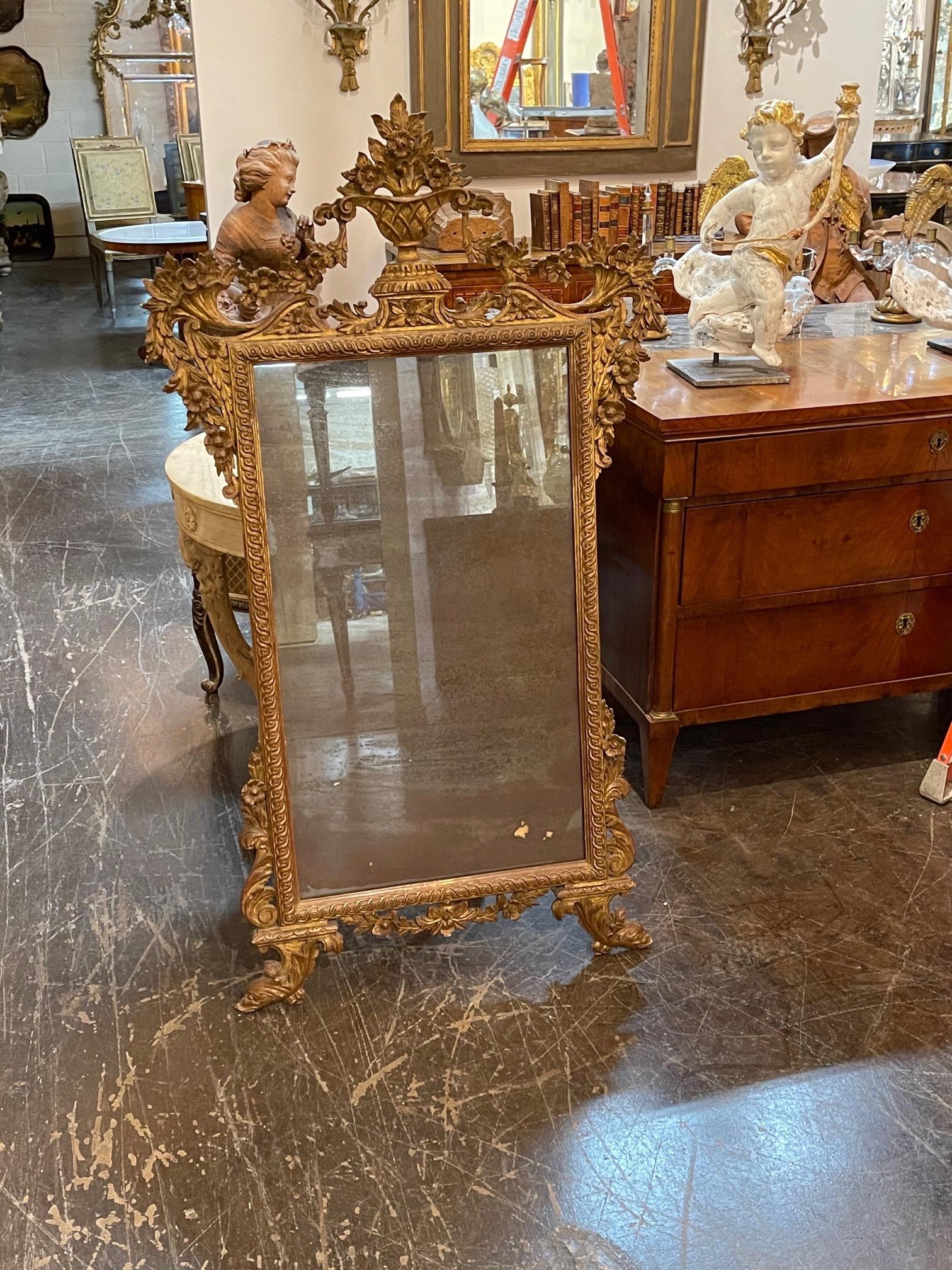 Beautiful 19th century Italian carved and giltwood mirror. Very fine carving including an urn with overflowing flowers. Lovely!!