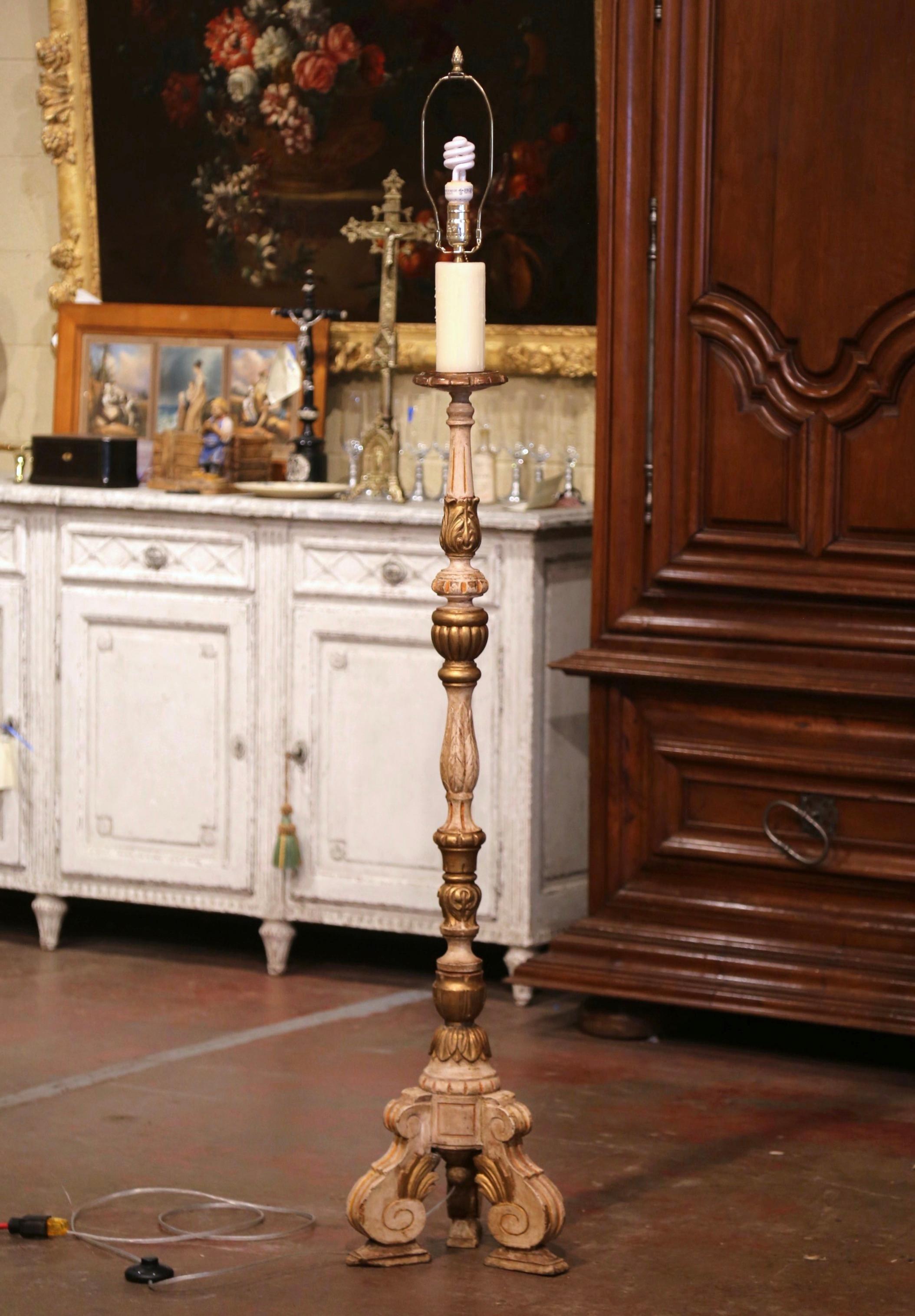This tall antique wood floor lamp was carved in Italy, circa 1890. The elegant light stands a scrolled tripartite pedestal base ending with scrolled feet. The fluted stem is decorated with acanthus leaf motifs and embellished at the top with a