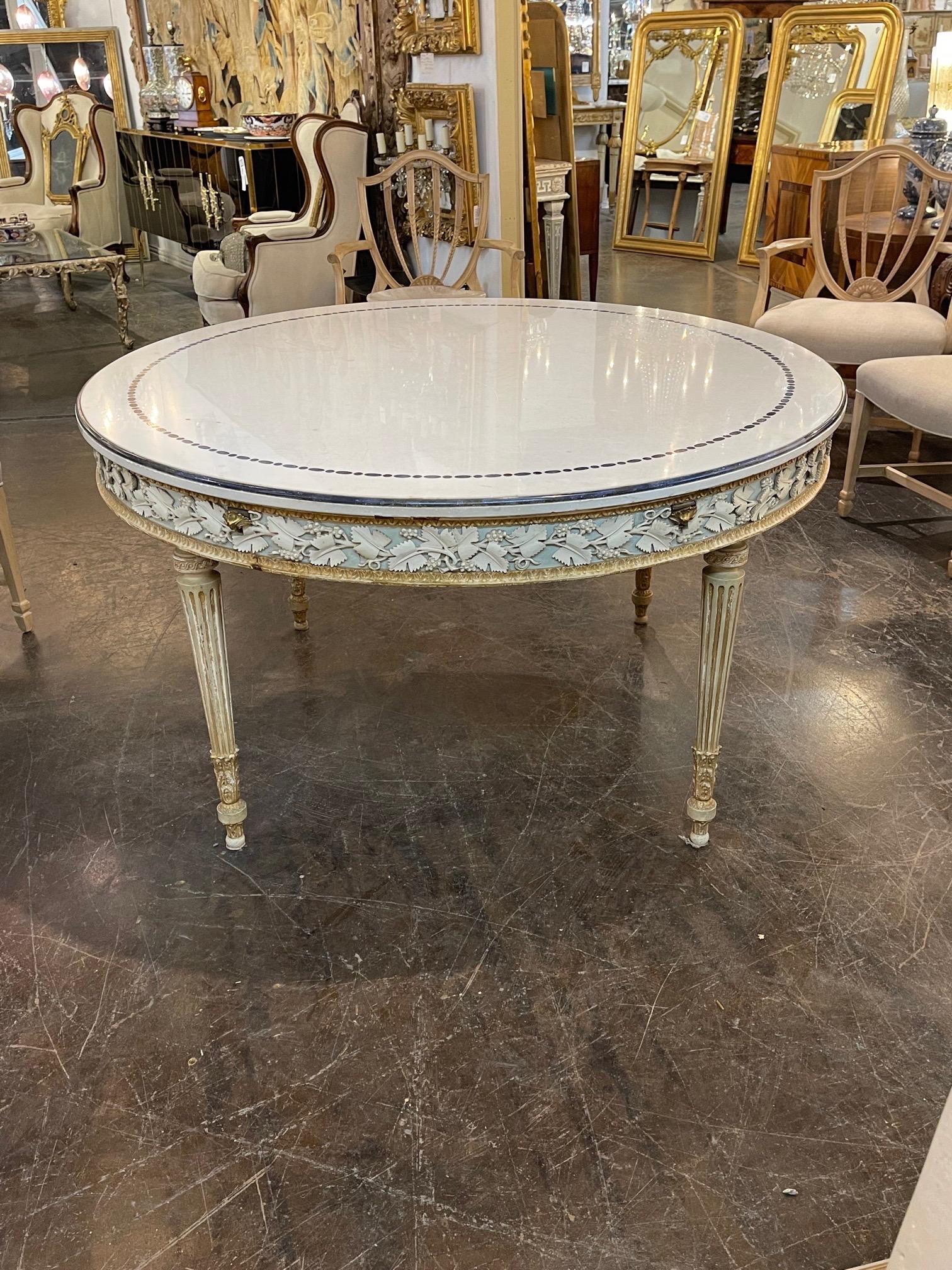Exceptional 19th century Italian carved and painted center table with inlaid marble top. Beautiful carved floral details on the outer border and a lovely white marble top. Very nice bronze fluted legs as well. Stunning!