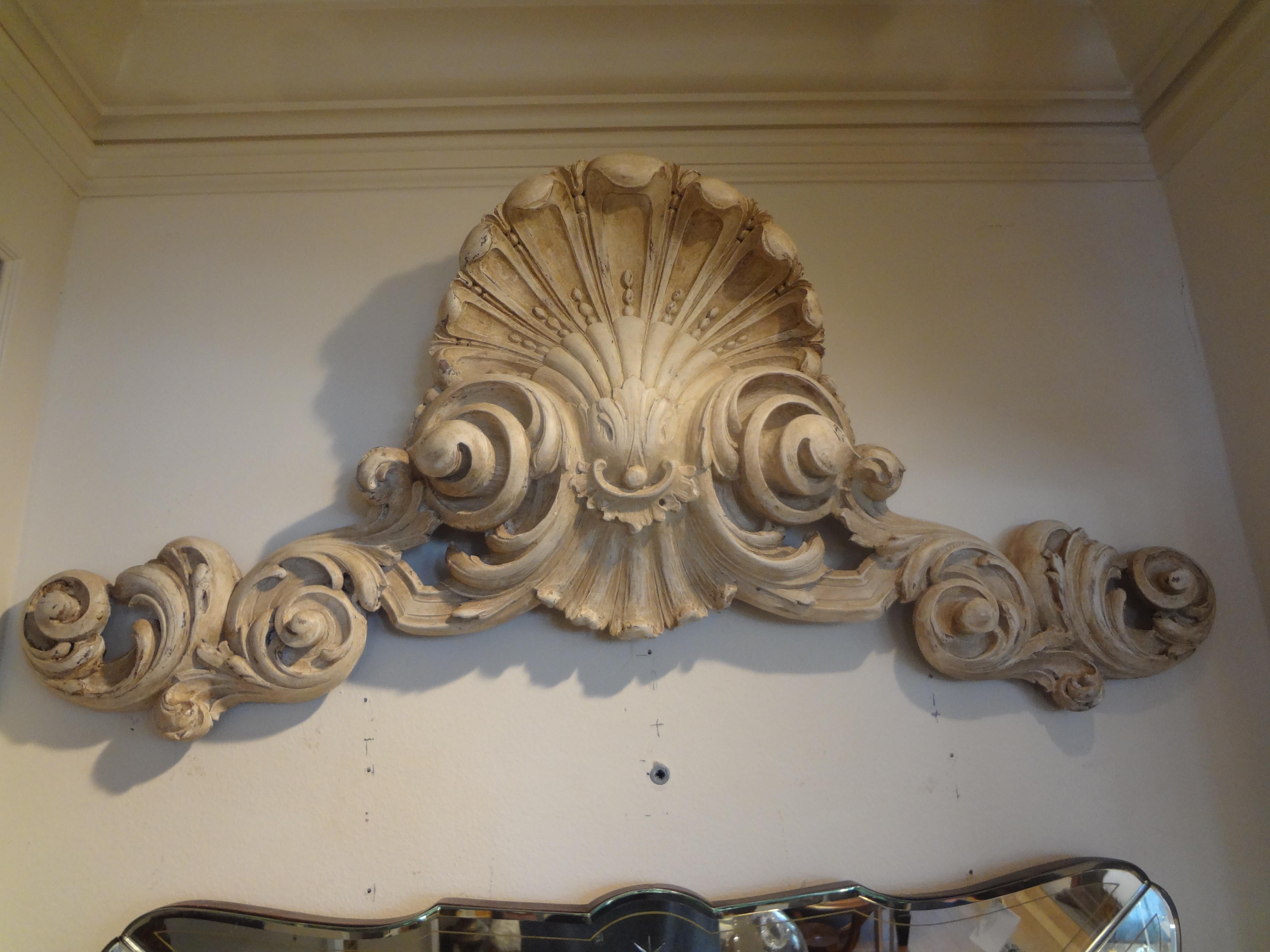 Well carved 19th century Italian architectural pediment. This Italian architectural element is painted a soft cream color and would look great above a doorway or used as a wall mounted sculpture.