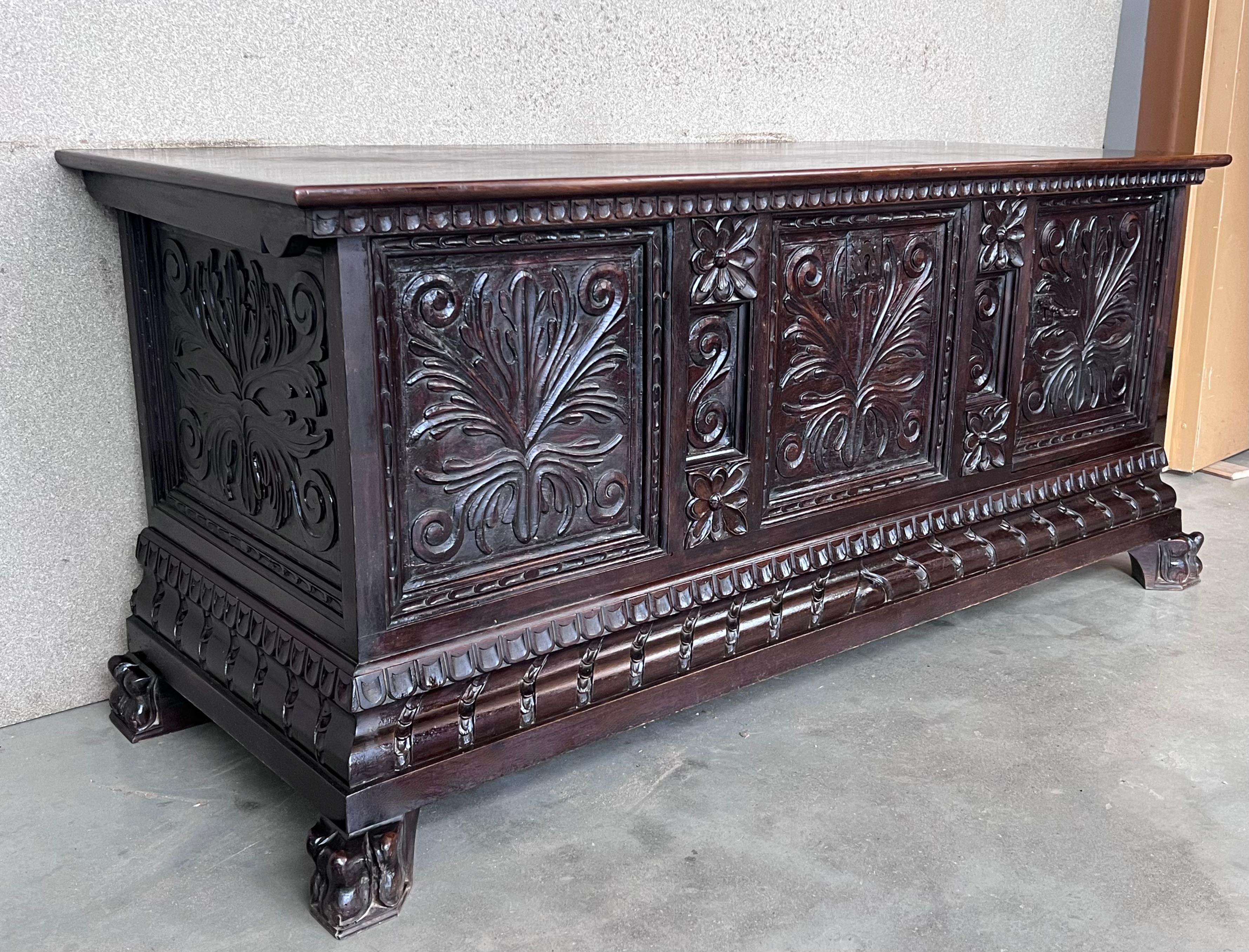 Place this elegant antique coffer at the foot of a king size bed. Crafted in Italy, circa 1880, the rectangular trunk stands on bracket feet. Heavily carved on all three sides with arch and foliage decor, the cabinet features carved panels on the