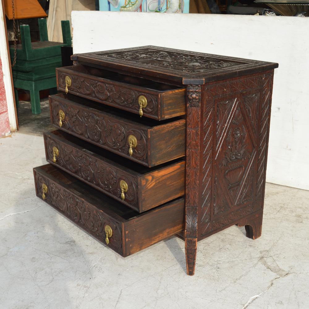 19th century Italian Renaissance Revival Dresser
 
 
Mid-19th century carved dresser features a facade of hand crafted animals and botanical motifs with a prominent coat of arms on top. Four drawers.

Oak with a rich patina finish, circa mid-1850s.