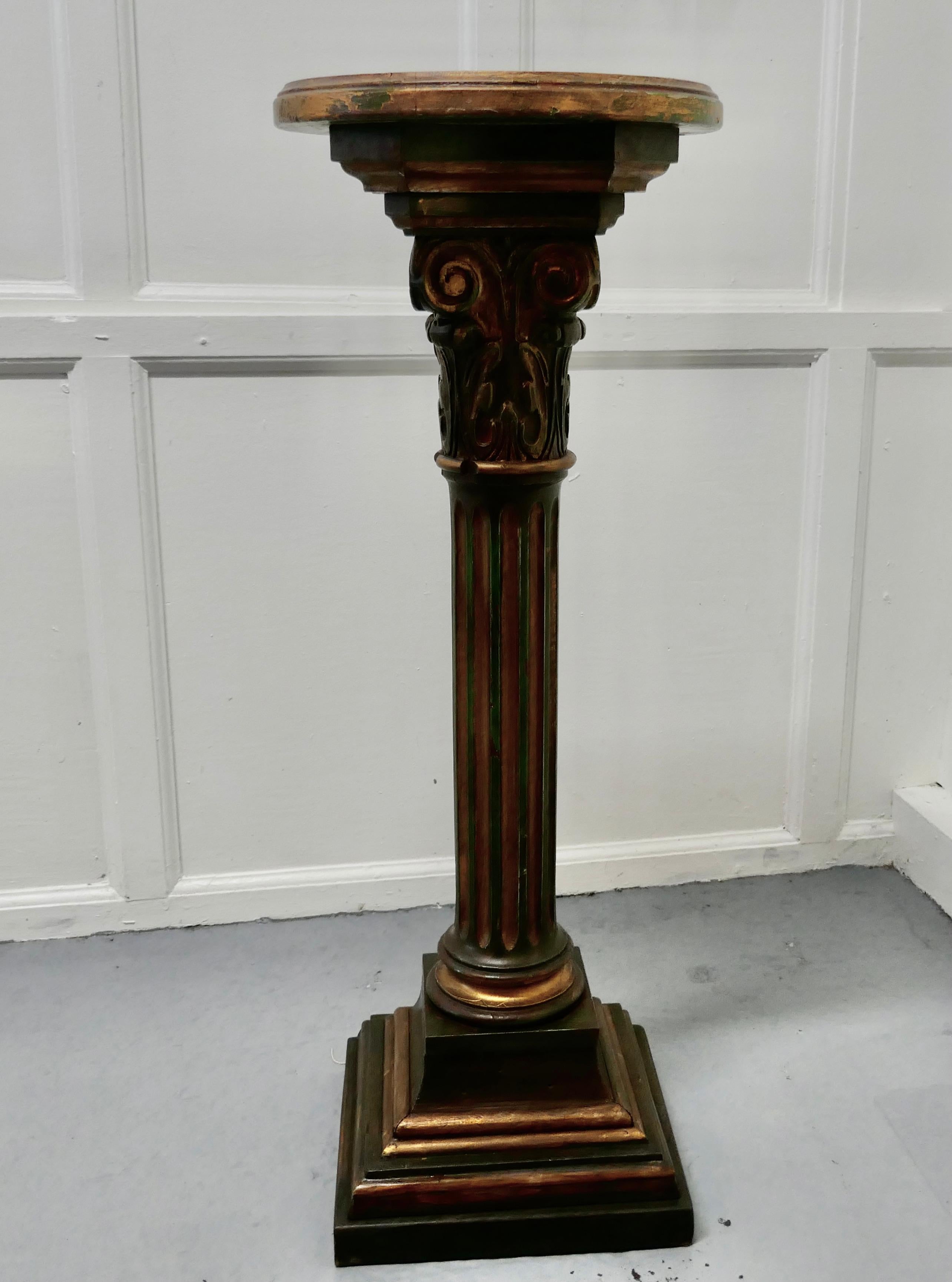 19th century Italian carved gilt wood column display pedestal

The column is set on a square stepped base, the central column is deeply reeded and has a round platform top on a carved corinthian support 
The column is gilt and painted in dark