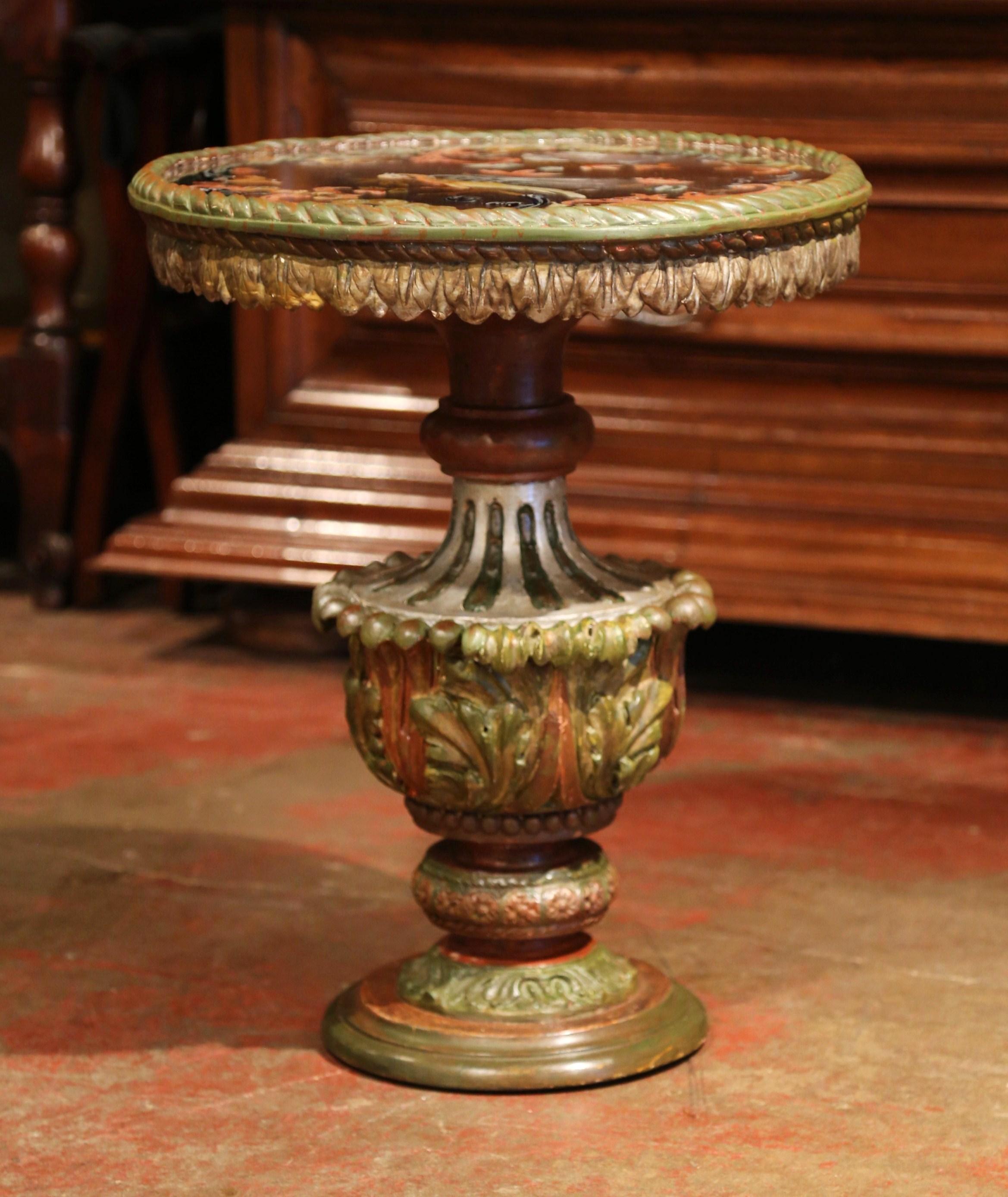 Place this elegant, antique, Italian pedestal table next to a sofa or a chair. Crafted in Italy, circa 1860, the dramatic table features a carved, urn-shaped base on circular stand. The round tabletop is a reverse painted glass top (or verre