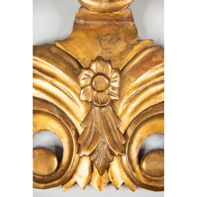 A gorgeous 19th-century Italian gilt wood architectural fragment carving / wall swag / hanging wall ornament. This stunning architectural element has a lovely flower centerpiece with carved scrolls and leaves and retains the beautiful original gilt