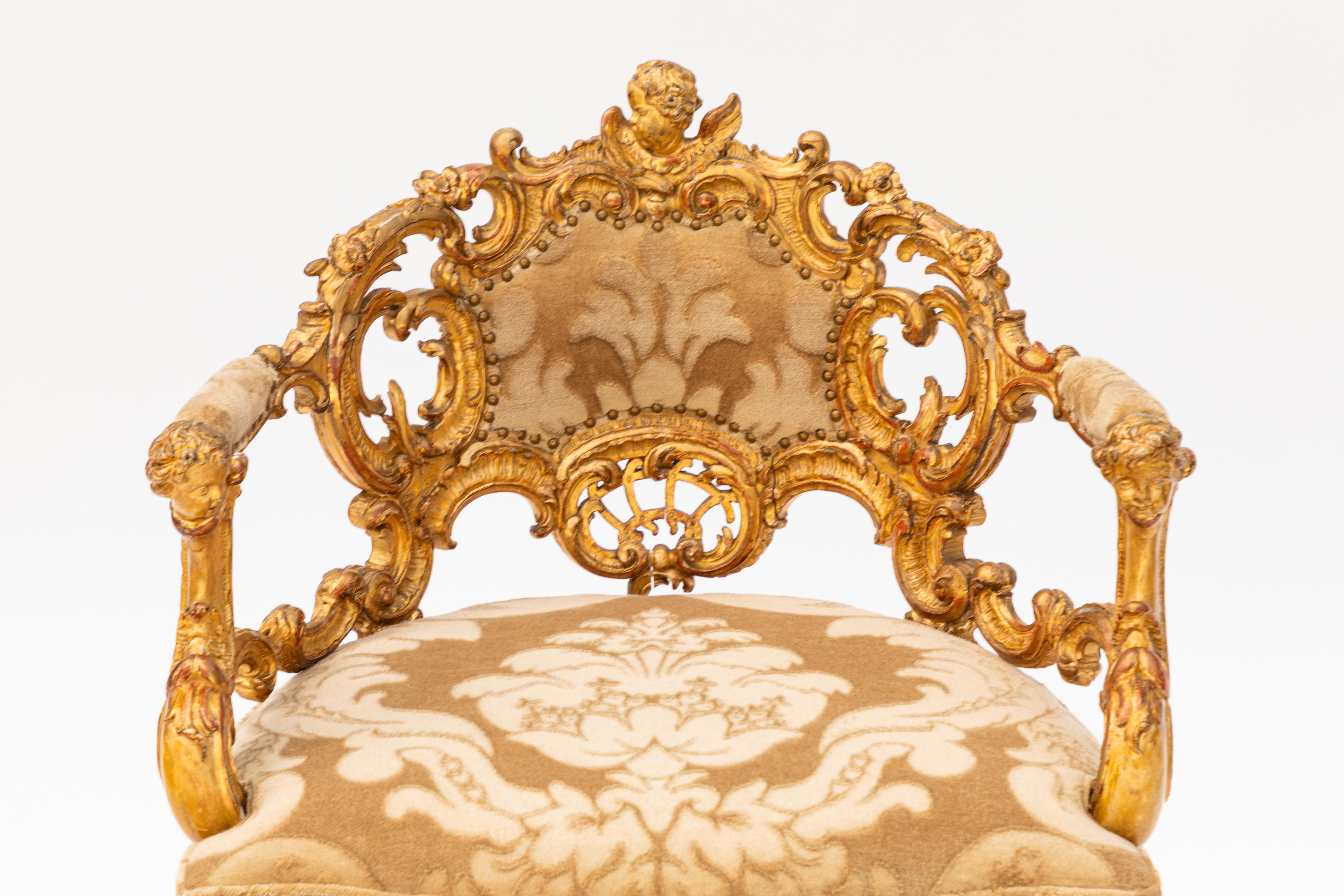 Single 19th century Italian carved giltwood armchair with cherub motif. Newly upholstered with silk mohair from Corragio.