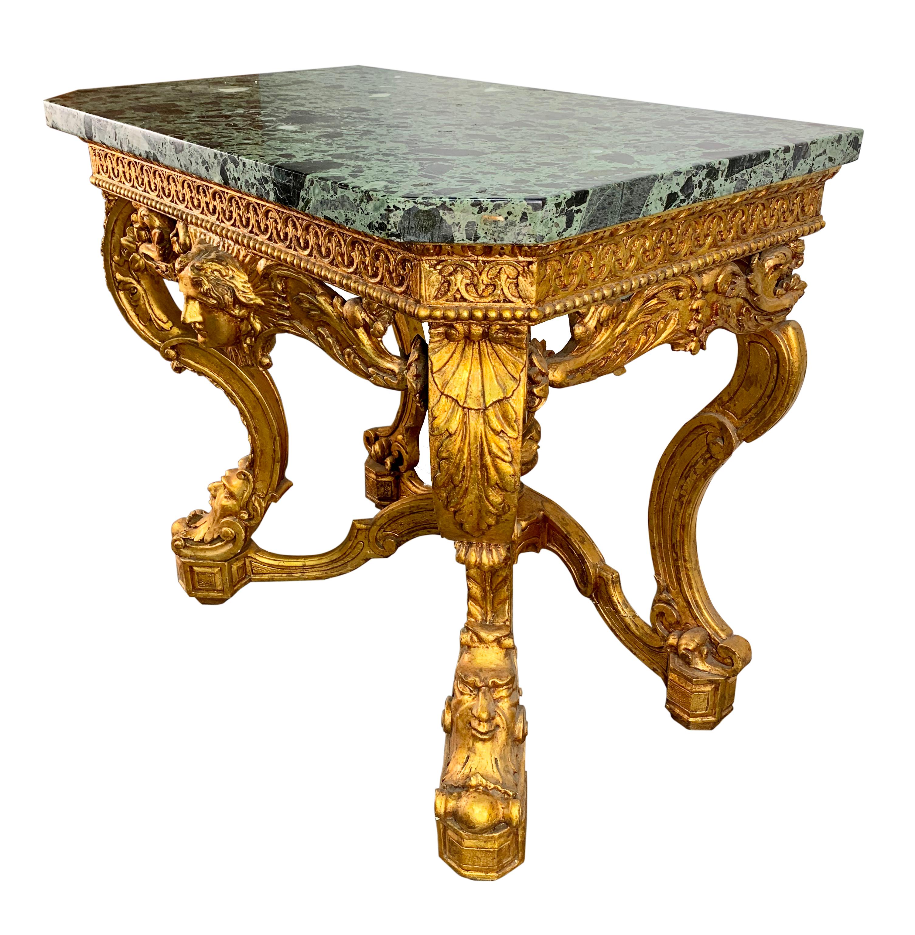 A handsome Italian 19th century carved giltwood console table with Brèche d'Alep marble top. The rectangular form centered by a female mask, raised on four curved form legs inter-joined by a stretcher having a basket with fruit and flower. The