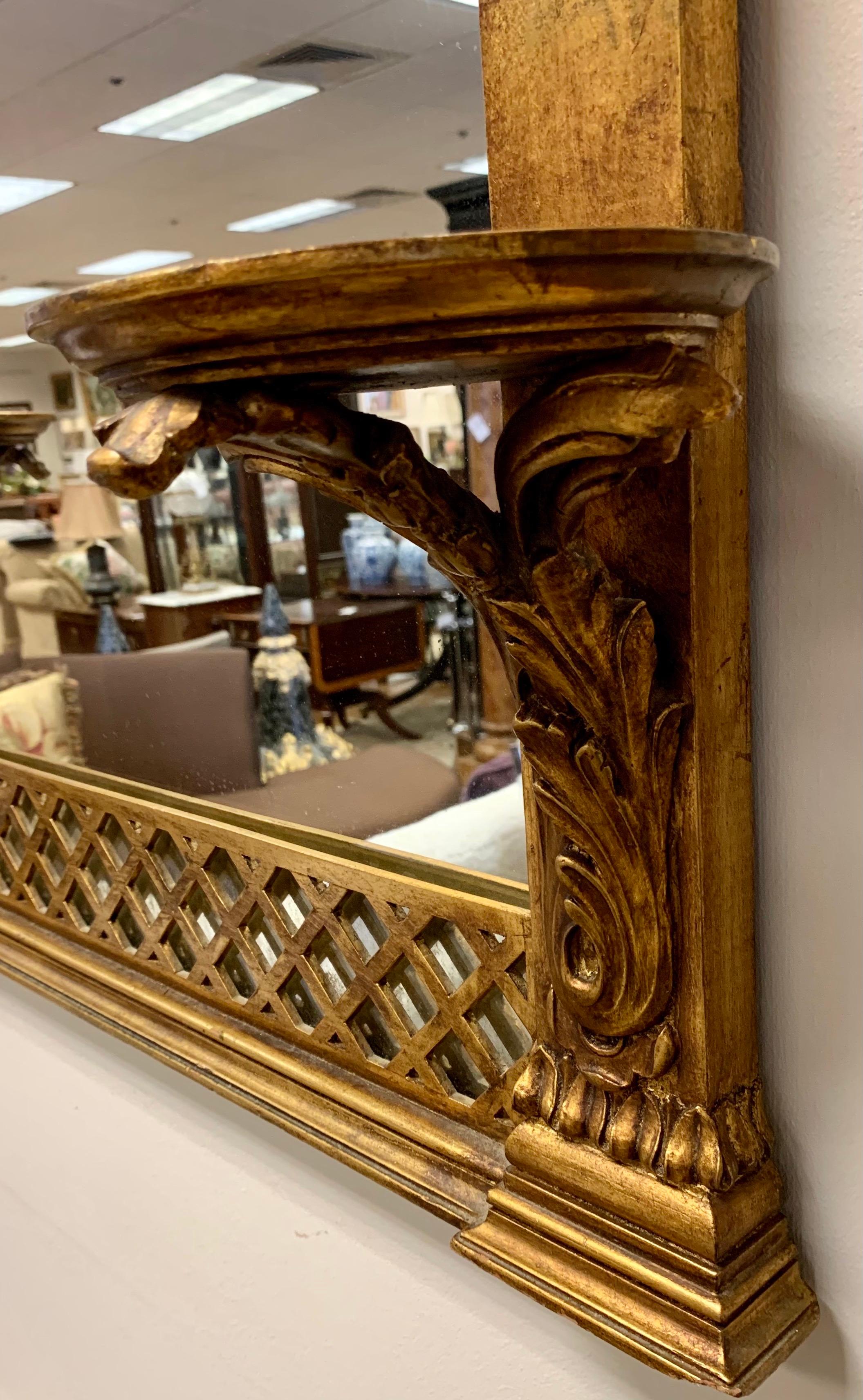 19th century Louis XVI period Italian mirror with crest featuring a medallion with swags and arrows. Bottom portion of mirror has ornately carved wall brackets on each side.