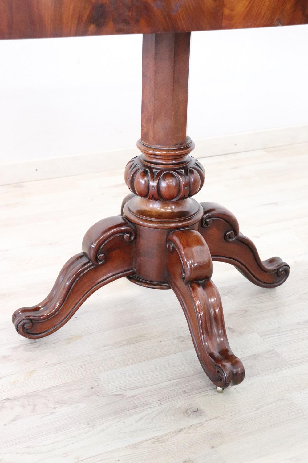 Beautiful antique game table in precious mahogany wood carved. When the table is closed, the table becomes smaller and can be used as an elegant console. The opening is very simple. The open top is covered with green cloth suitable for the game