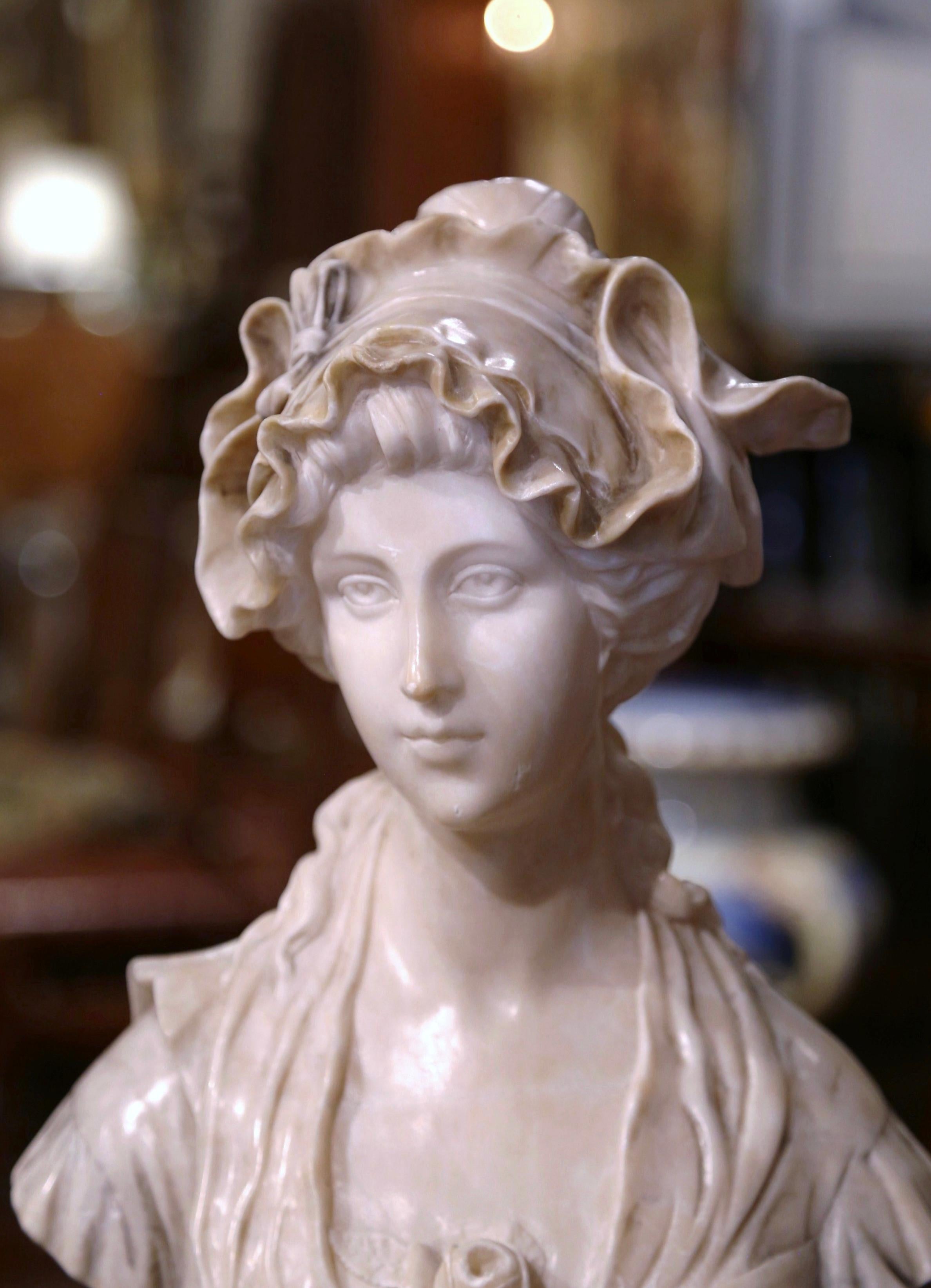 Decorate a shelf or an office with this elegant antique bust. Sculpted in Italy circa 1880 and built in two pieces, the marble figure sits on a round swivel base and features a young female beauty, dressed with beautifully carved frilled bonnet and