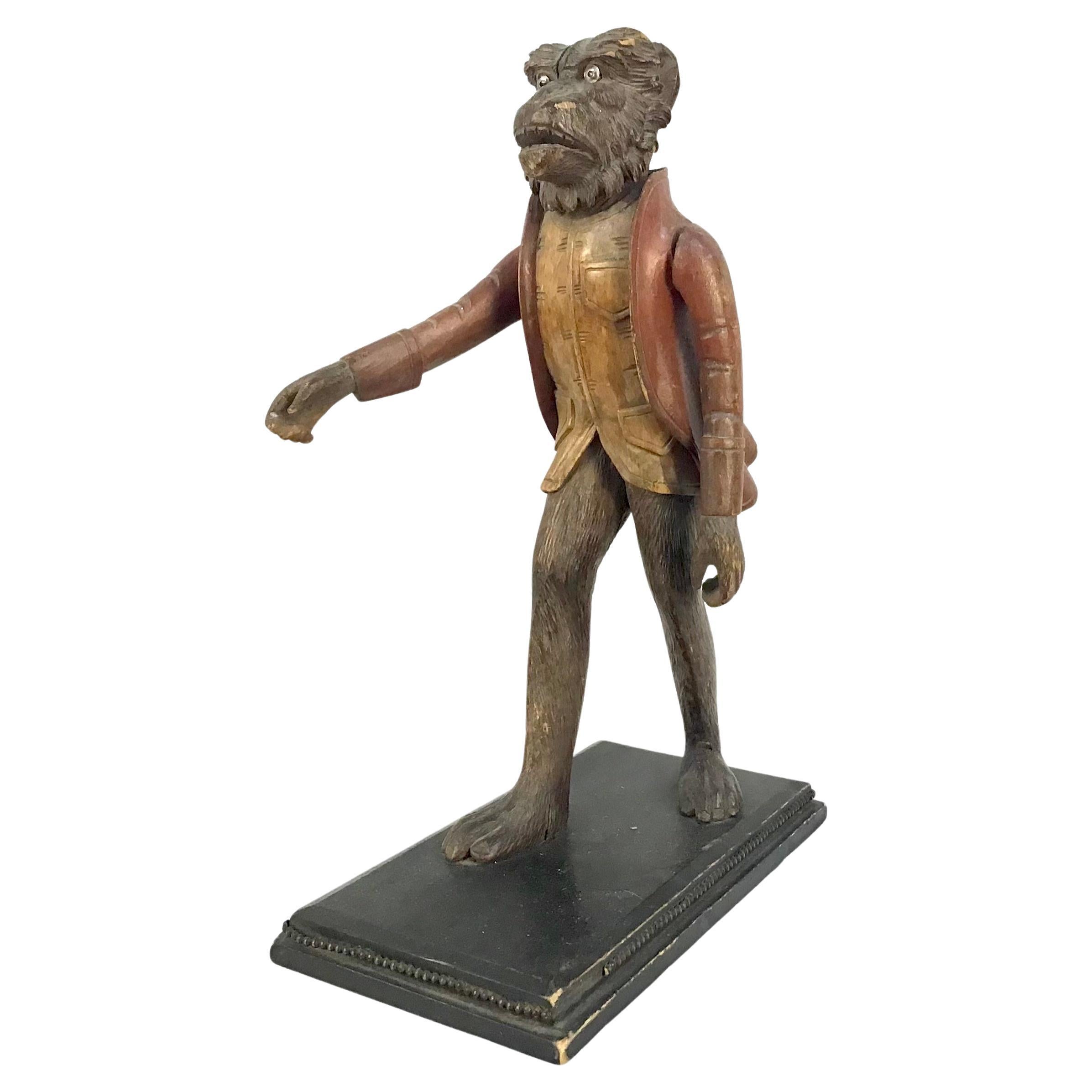 A finely carved wooden monkey butler figure on stand, glass eyes, open mouth with teeth, made to hold a tray in its outstretched arms / hands, Italian early 19th century. A rare find.