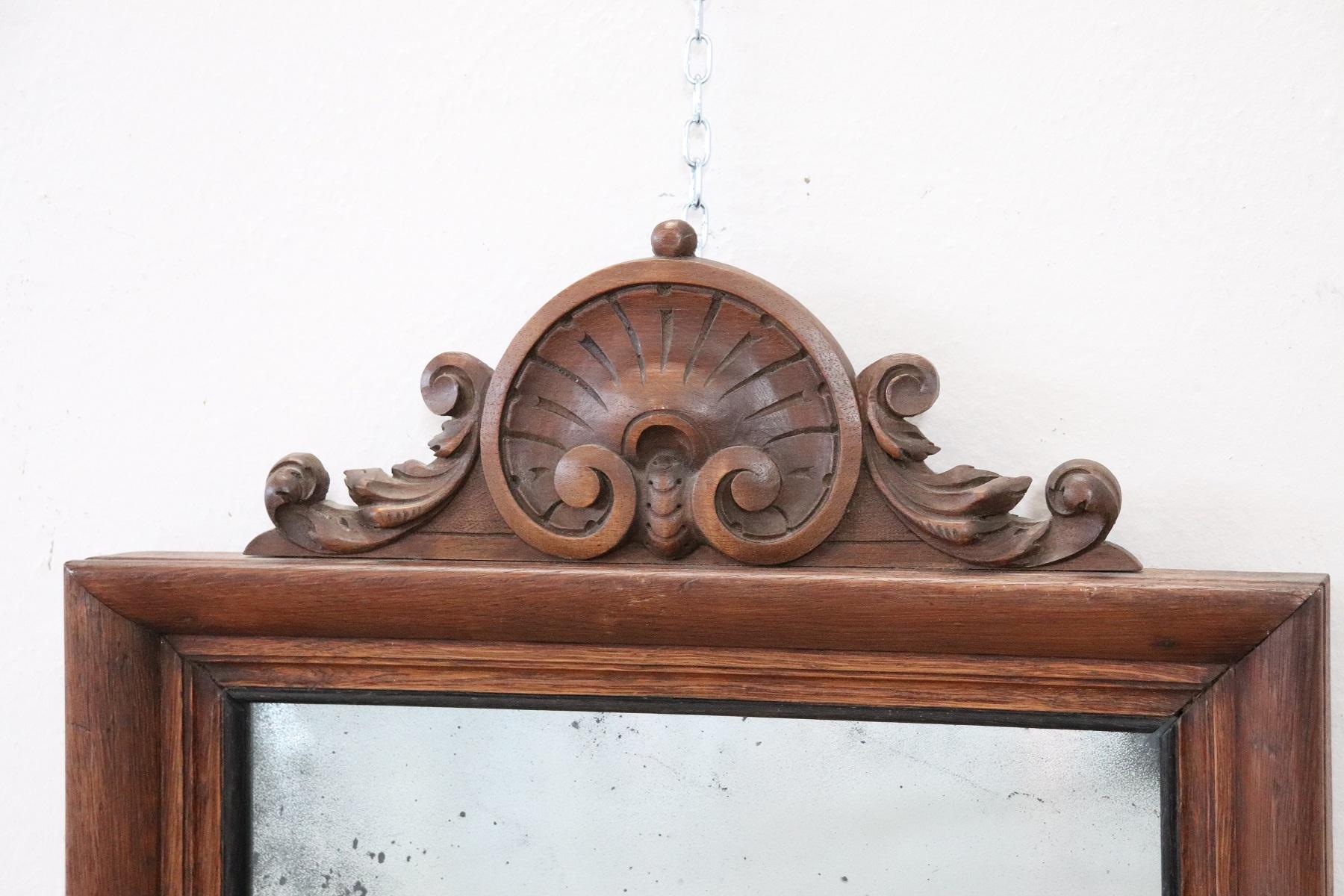 19th century Italian carved and oakwood wall mirror about 1880s with refined decoration. Particular decoration carved in the wood forms a shell. The mirror is ancient to mercury so it presents imperfections look good at the photos. Perfect wood