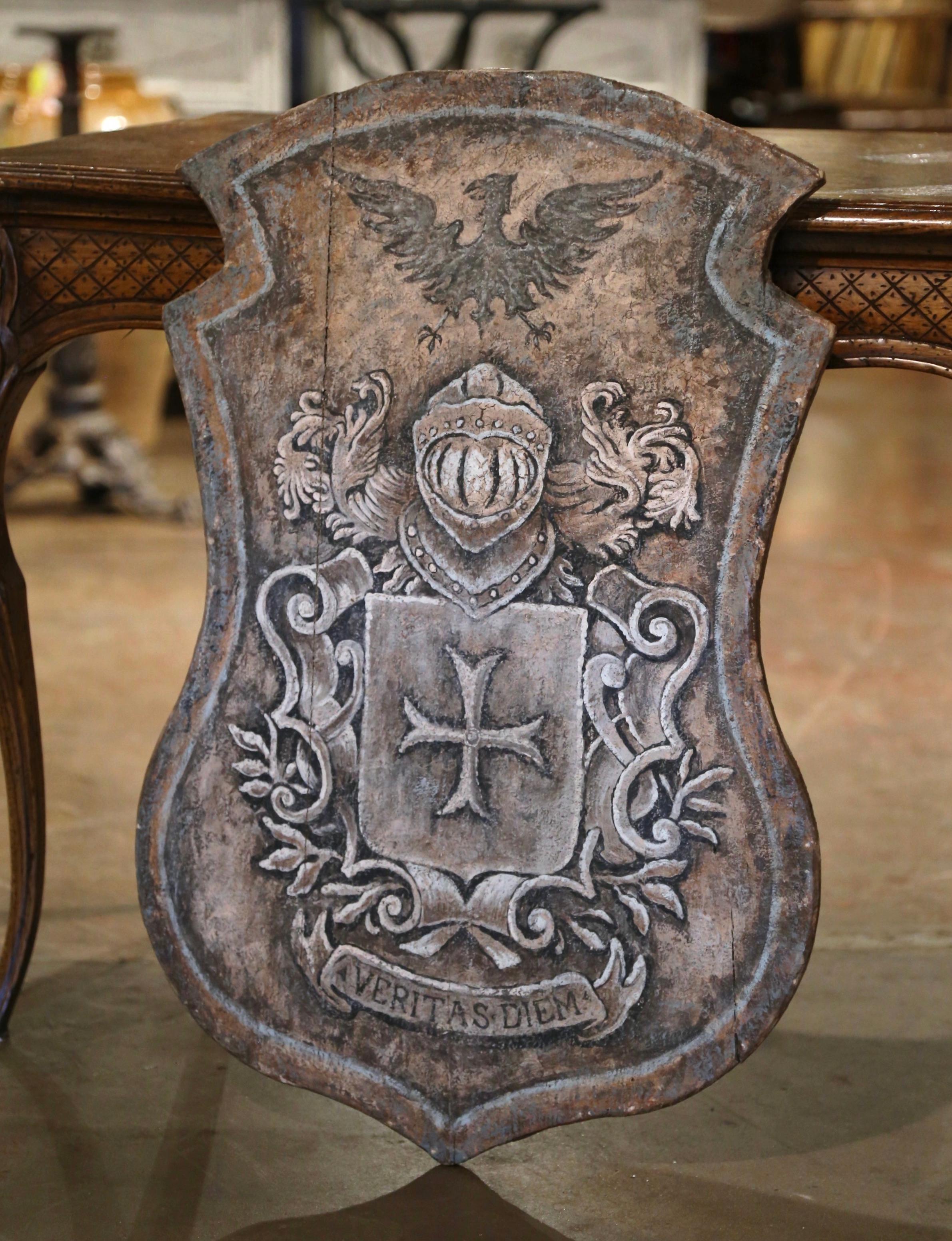 Embellish your study or library with this elegant, antique decorative wall hanging coat of arms. Carved in Italy, circa 1870, the traditional, hand painted crest features a central shield decorated with the Christian Malta cross, situated underneath