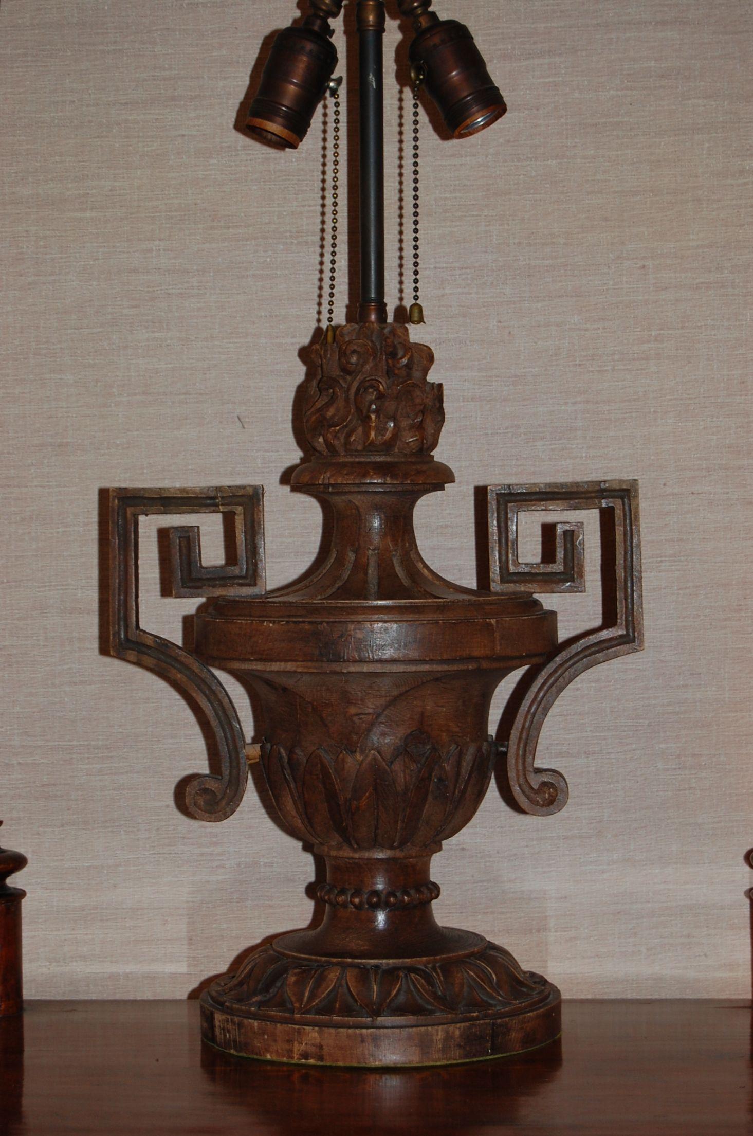 An interesting antique wooden final that has been drilled and wired as a lamp. The total height of the carved urn less the metal parts is 23 inches.