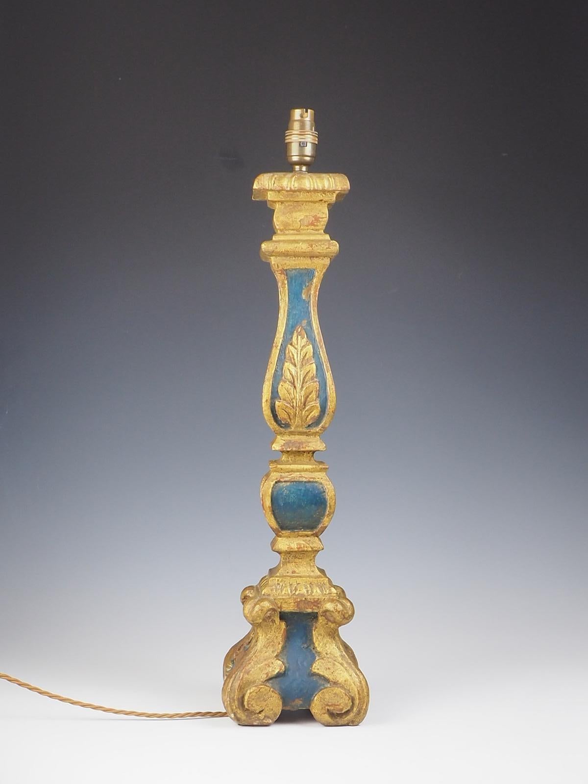 This 19th Century Italian Carved Polychrome Blue and Giltwood Table Lamp is a stunning piece that showcases the exquisite craftsmanship of the era. Made from carved, painted, and parcel-gilt wood, this table lamp is a true work of art. The stem of